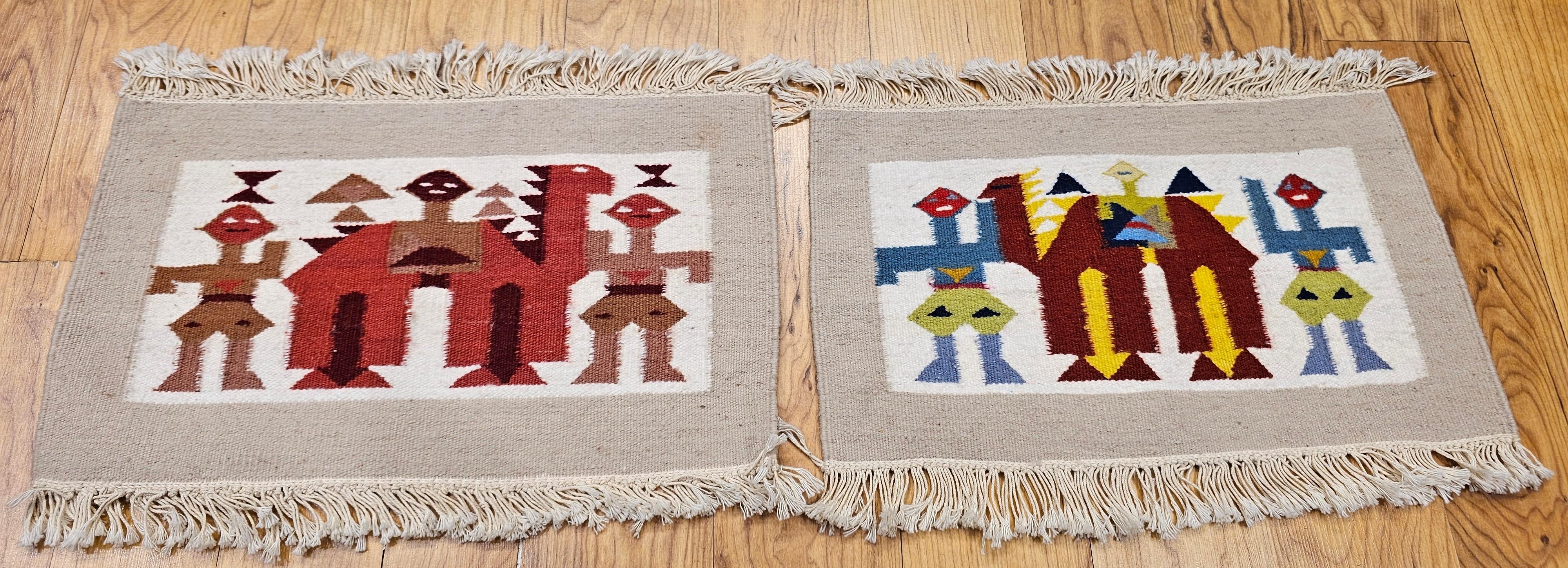 A pair of hand woven African tapestries of camels and humans.  The tapestries were hand woven in the late 20th century in Tunisia, North Africa.  The African Hand Woven tapestries depict a camel with human forms around it.    Although the design is