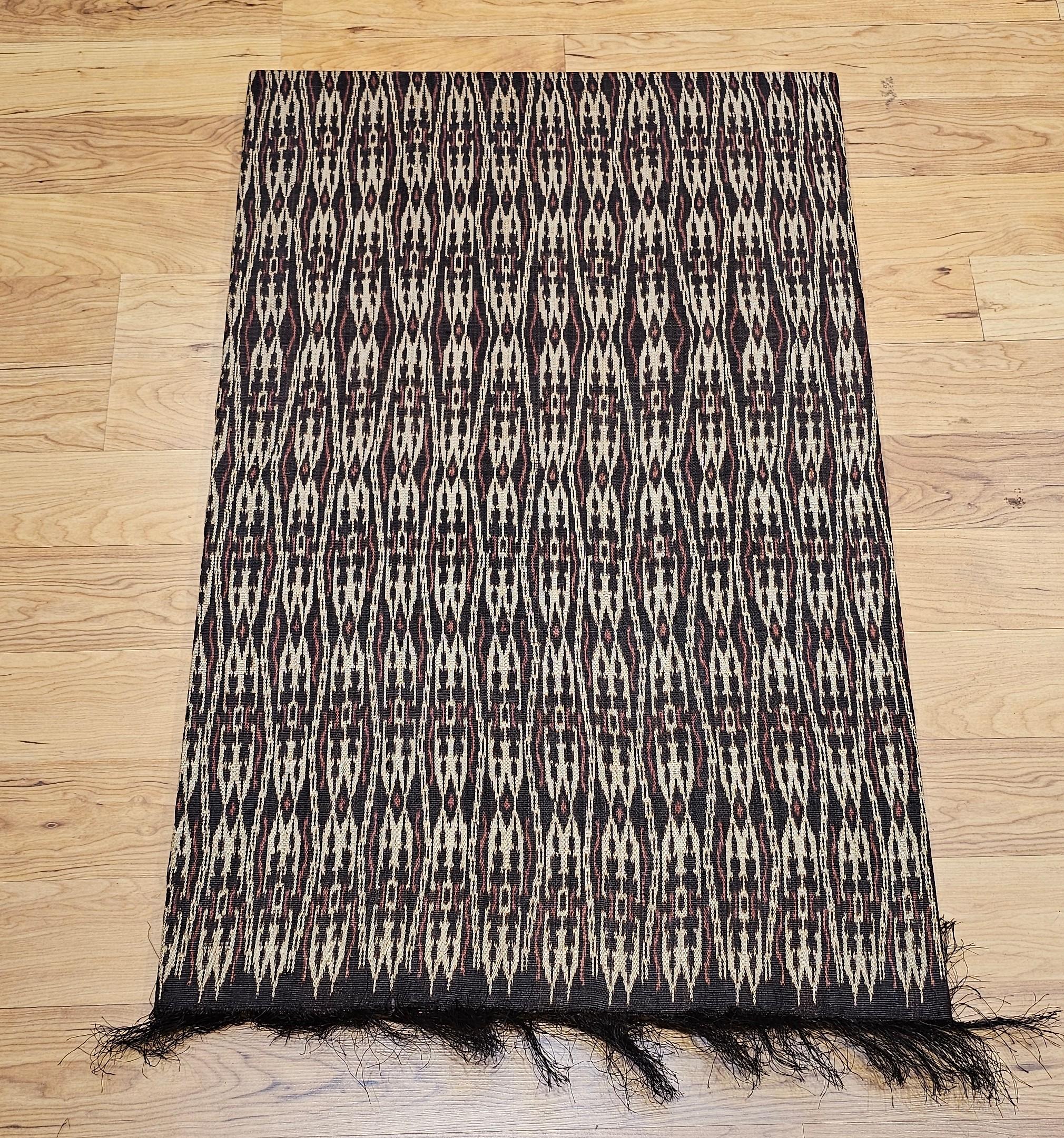 Elevate your interior space with this exquisite vintage hand-woven African textile, elegantly mounted as contemporary wall art. Featuring a rich palette of earthy brown, deep burgundy, and soft ivory, the design echoes the rhythmic patterns of