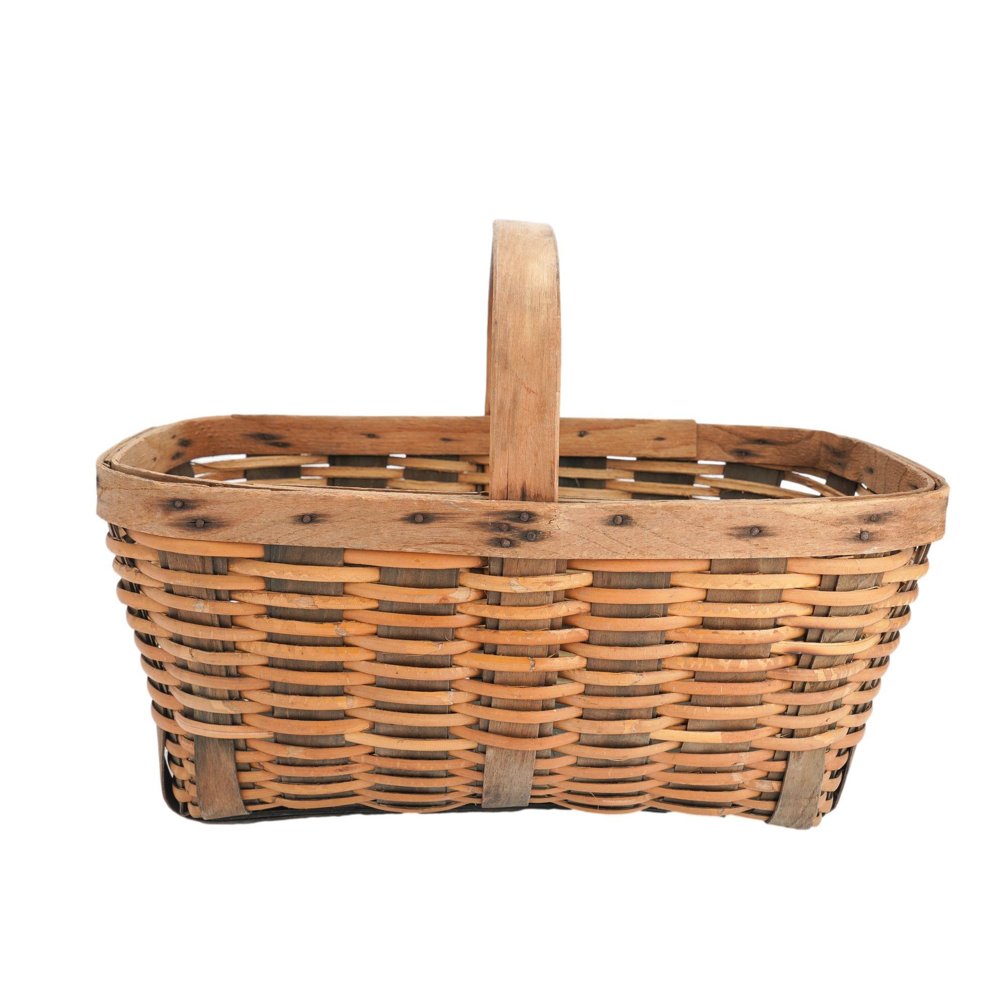 Vintage rectangular hand woven basket of bamboo with ash ribs which continue across the bottom, rim, and fixed loop handle. The rim and handle are attached with round head iron tacks.

Early 20th century.