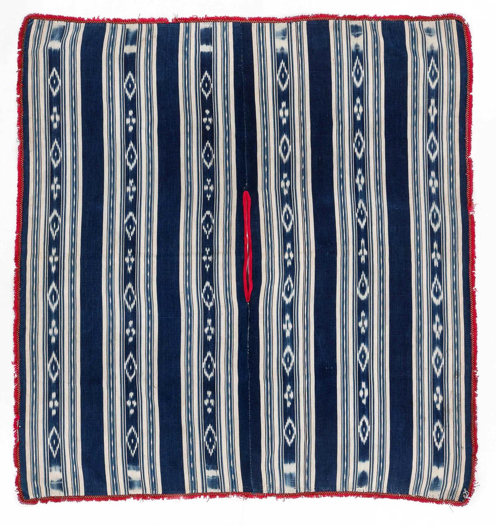 A Man's Special Occasion Poncho collected in Ambato, Tungurahua Province, Central Ecuador circa 1940-50s. The finely woven poncho was hand-sewn from two large matching panels, each with three vertical white bands consisting of multiple stripes on an