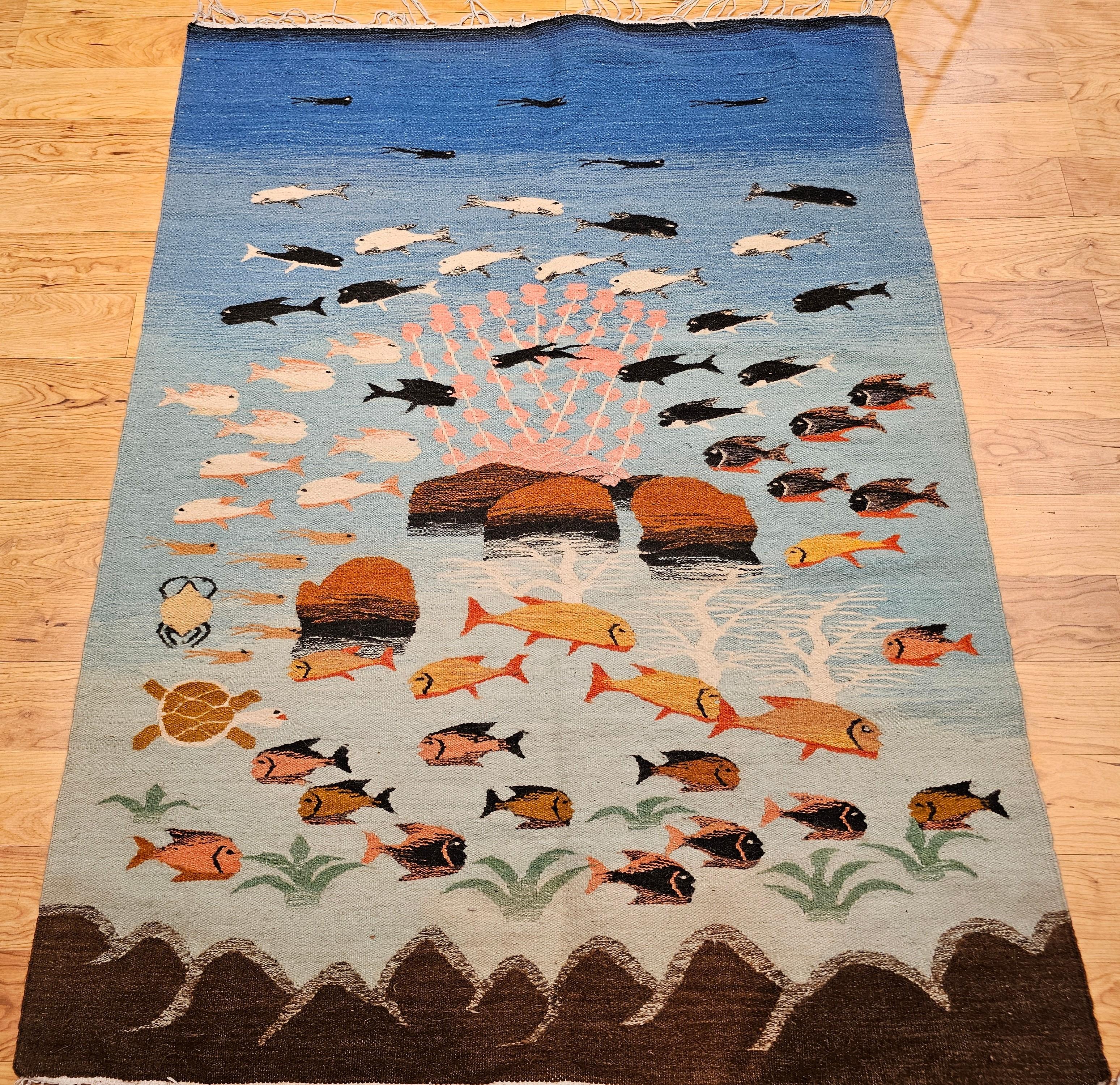 A striking vintage hand-woven flat-weave kilim rug from the mid-20th century, beautifully designed in the mid-century modern aesthetic. This unique textile depicts a whimsical and richly detailed underwater ocean scene, featuring a variety of marine