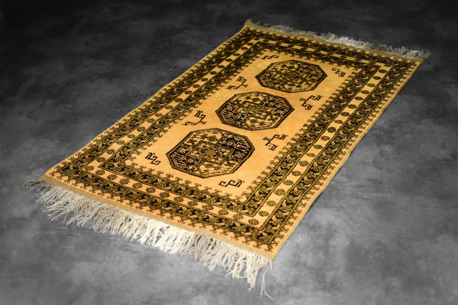 This Afghan Gold Ersari hand-woven oriental rug was made in Afghanistan during the 1930s. Also known as Golden Afghan. It is dyed in golden brown colors, using naturally obtained dyes. The center of the rug is a triple, geometric medallion,