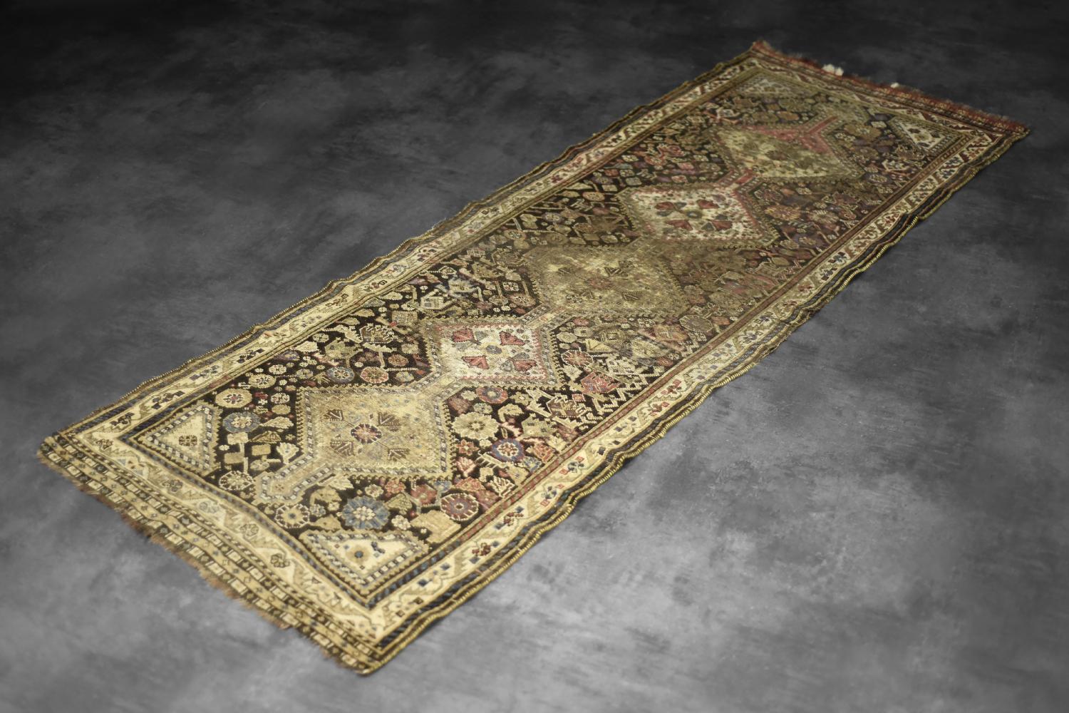 This hand-woven, long nomadic Qashqai rug was made in Iran during the 1920s. Naturally dyed in shades of green and beige. The central point of the rug is a five-piece, symmetrical medallion. The rug shows geometric, floral motifs.

Often called a