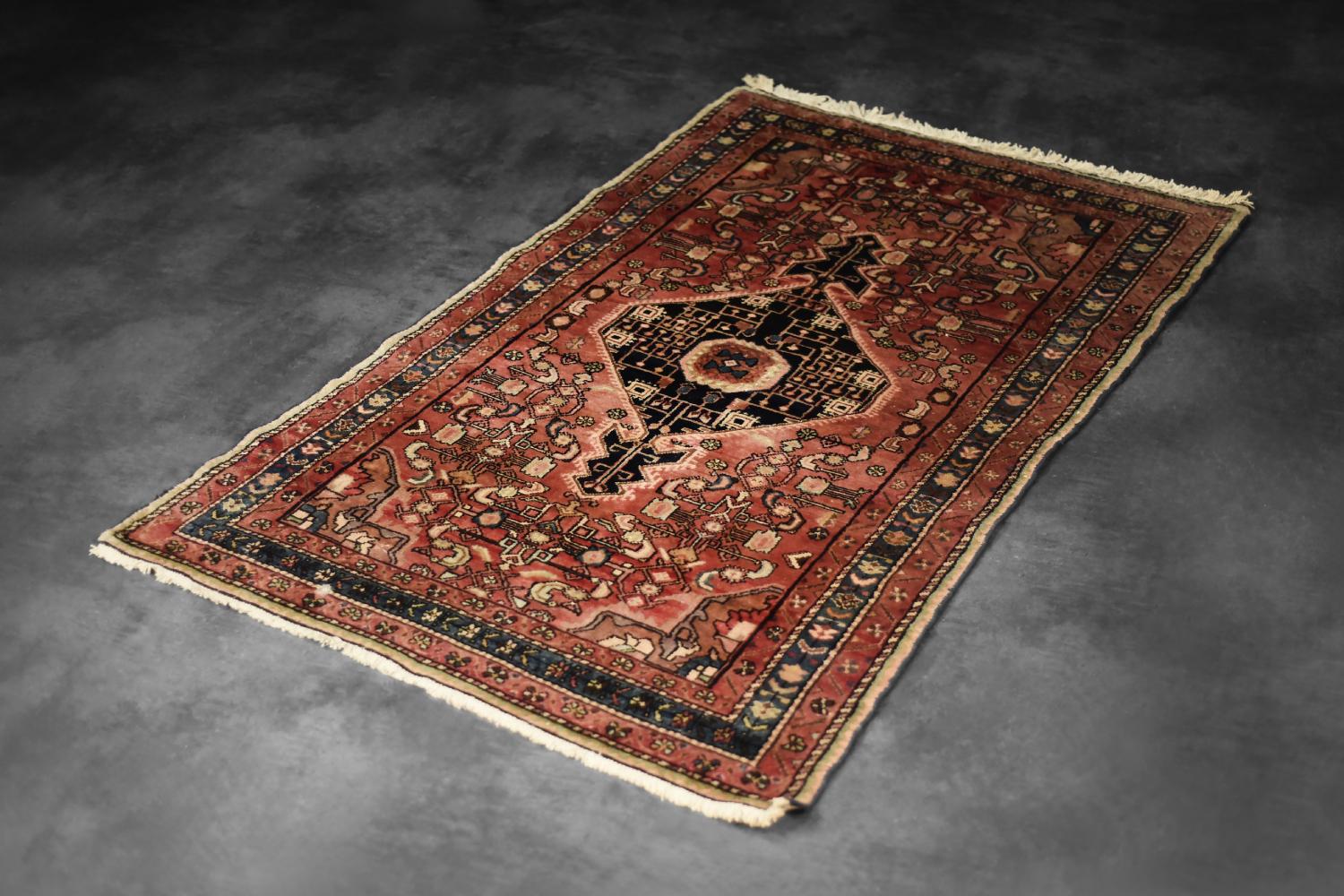 The hand-knotted oriental Zanjan rug was made in Iran during the 1960s. Traditionally flatwoven and dyed in shades of rustic red, black, and ivory, Zanjan or Zanjan Hamadan rugs are a type of traditional Persian rug originating from the city of