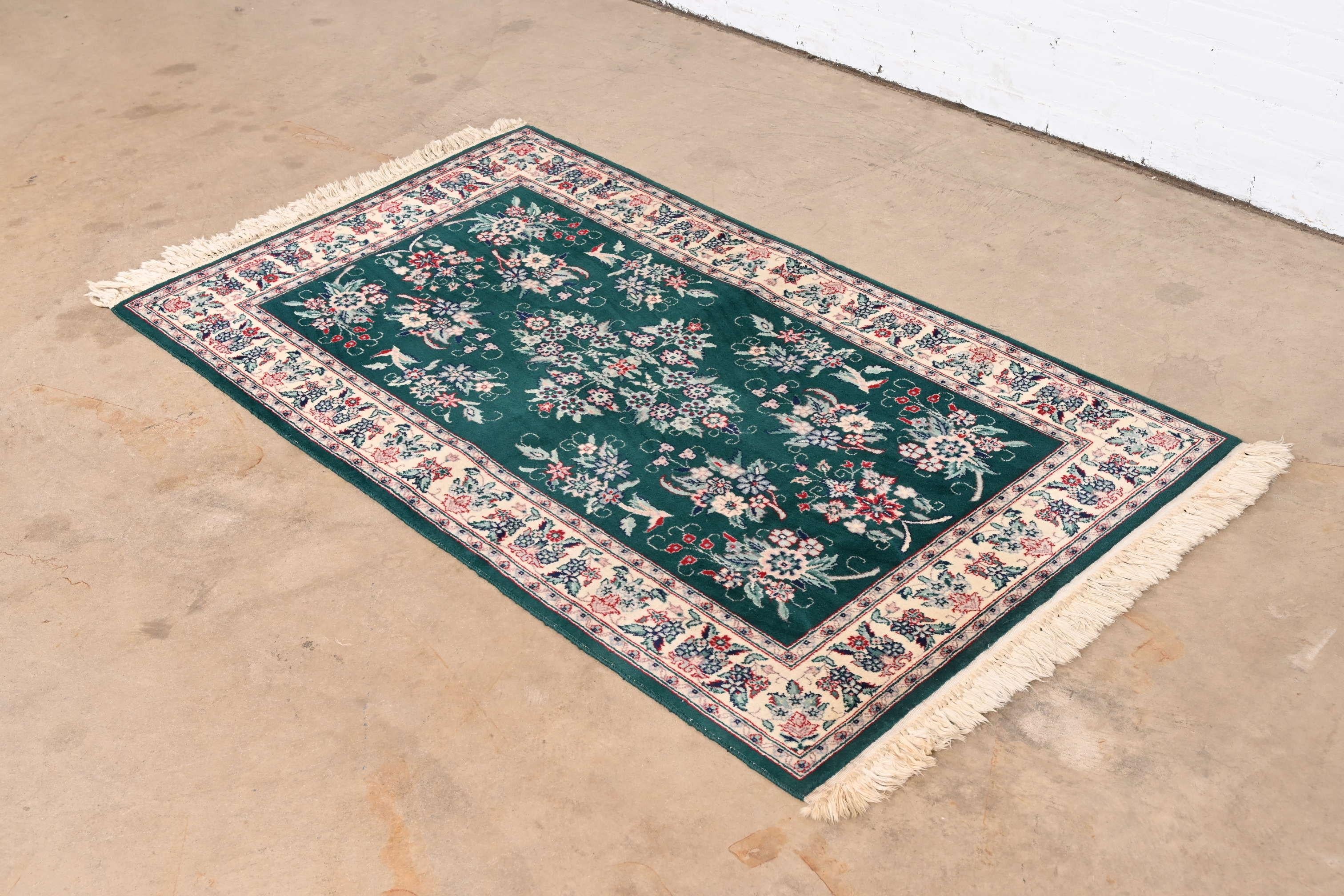 A beautiful vintage hand-woven Persian wool rug

Late 20th Century

Nice floral design, with predominant colors in green, burgundy, and ivory.

Measures: 36.5