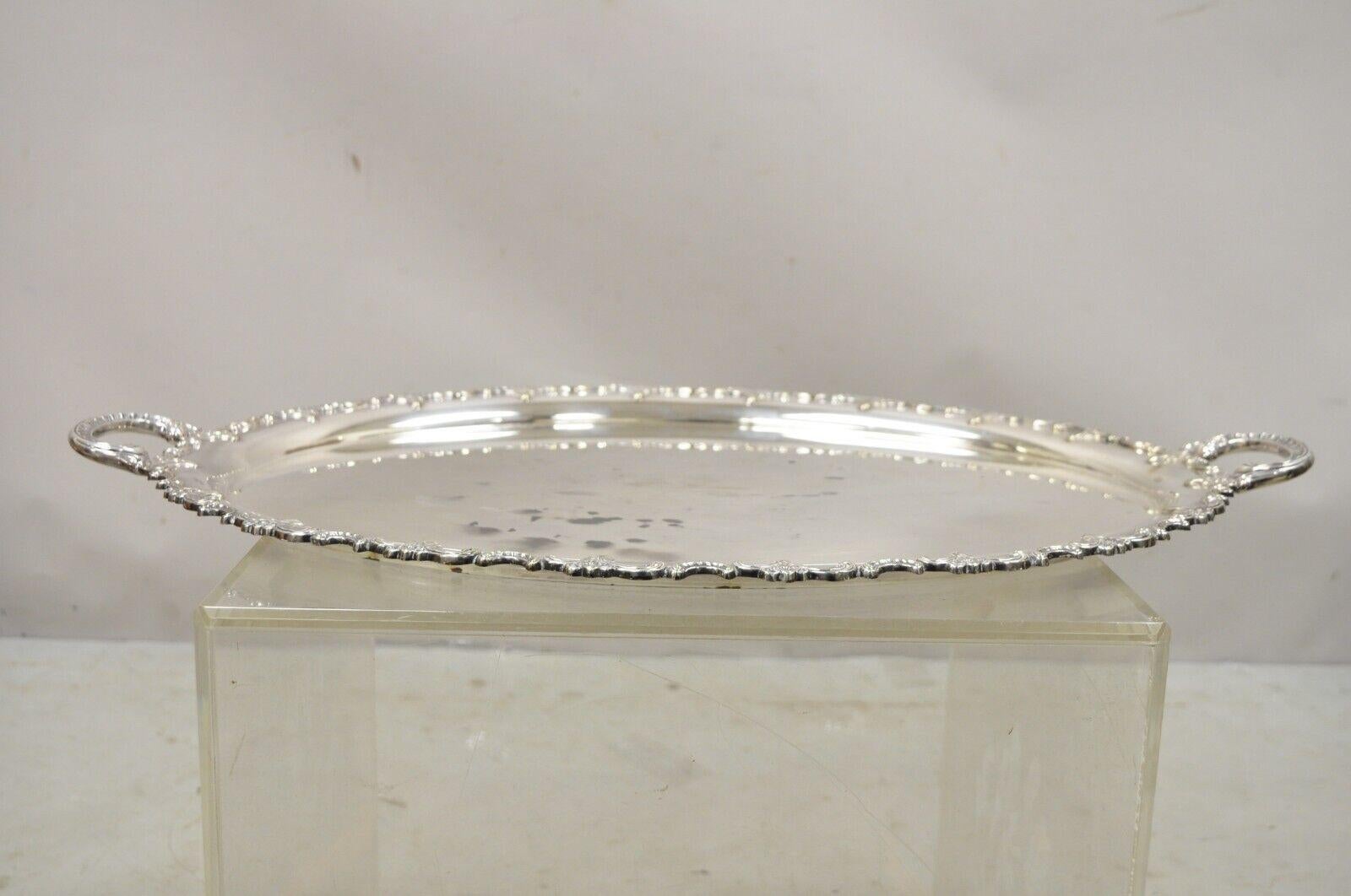 Vintage Handarbelt Alpacca silver plate oval tray serving platter. Item features ornate twin handles, decorated rim, oval form, original stamp, very nice vintage item, circa Age: Early 20th century. Measurements: 1.5