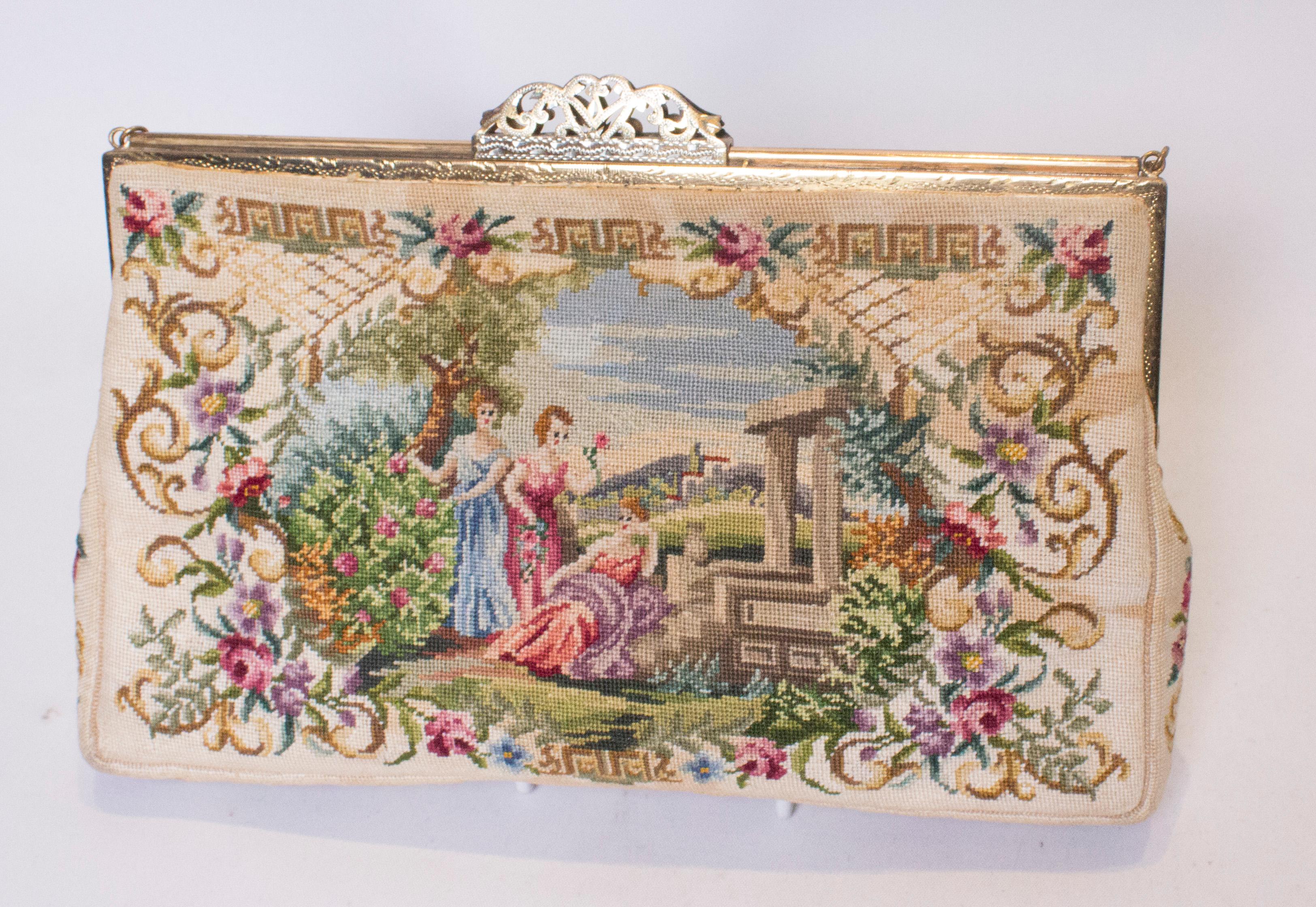 A sizeable vintage handbag with an interesting frame and clasp that has a slide opening. There is an attractive design of reclining ladies on each side. The bag is lined in satin with two pouch pockets.
Measurements: width 9 1 /2'',height 6'',depth