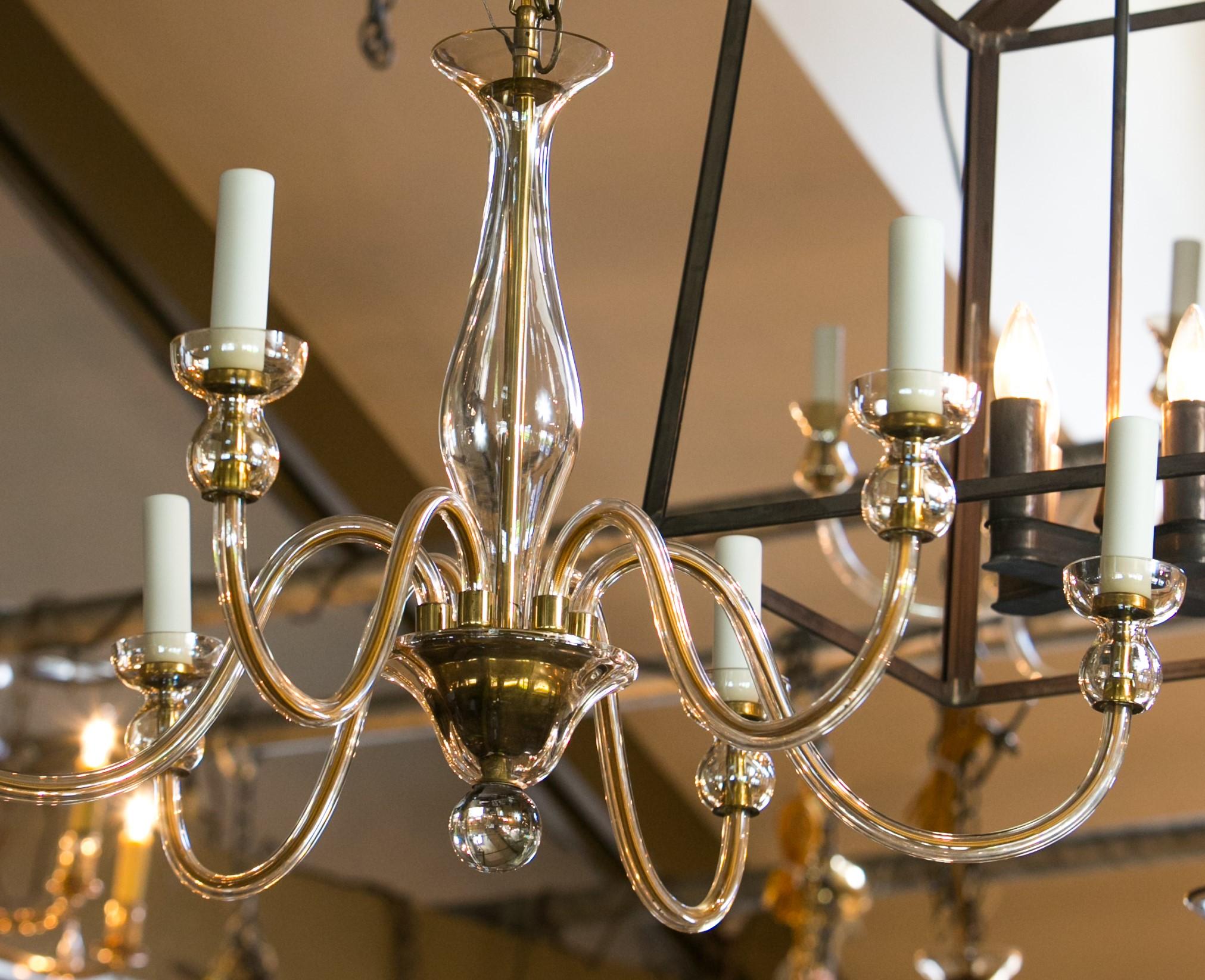 Murano pale amber glass chandelier with six arms. This vintage Italian hand-blown chandelier is newly wired for use within the USA. If one prefers a more tan color of candle sleeves instead of ivory (as illustrated), they can be changed out. This