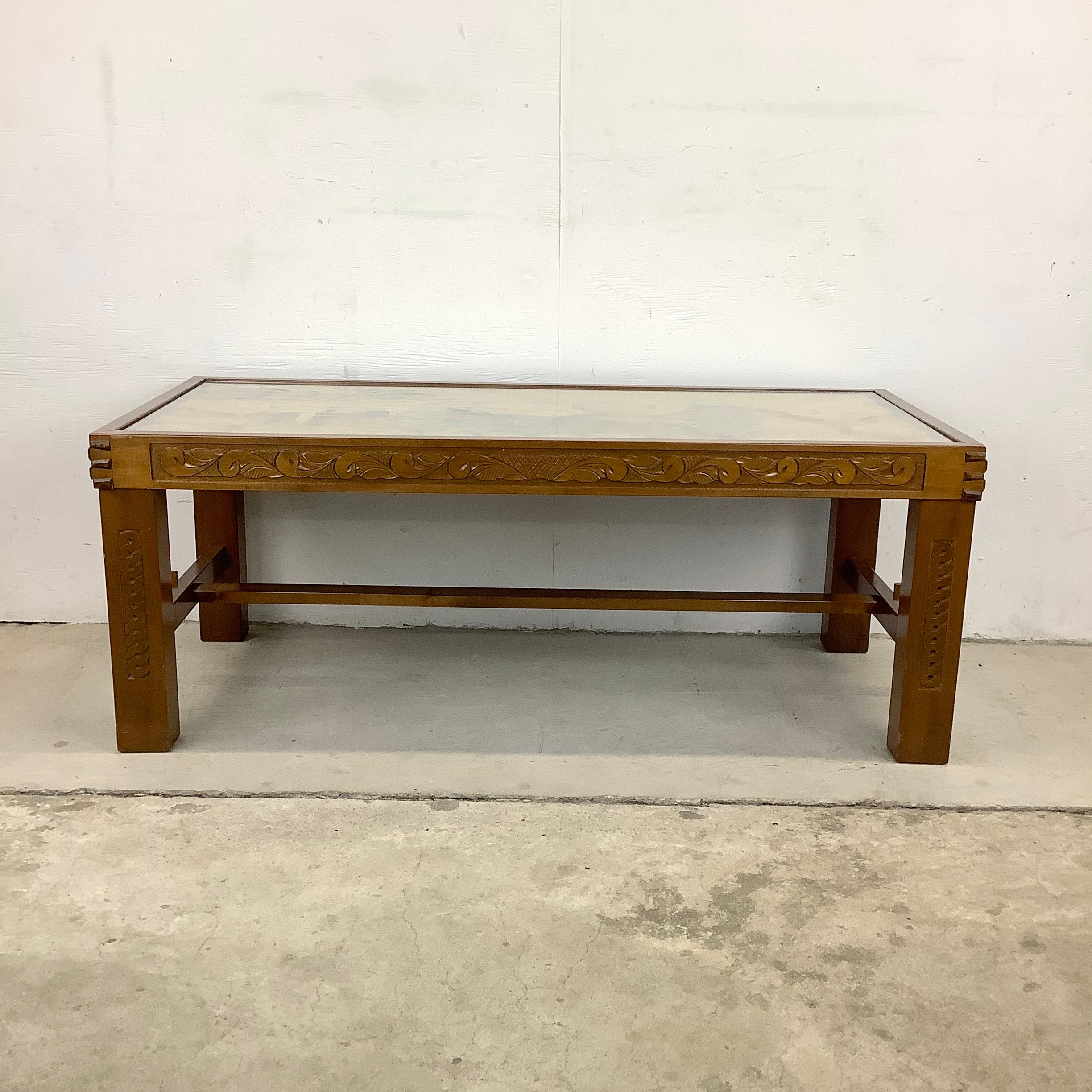 This unique illustrator style vintage coffee table features hand carved wooden table with glass top- charming country style carved scene makes an interesting centerpiece to any seating area.

Dimensions: 47w 21.25d 18.25h

Condition: age