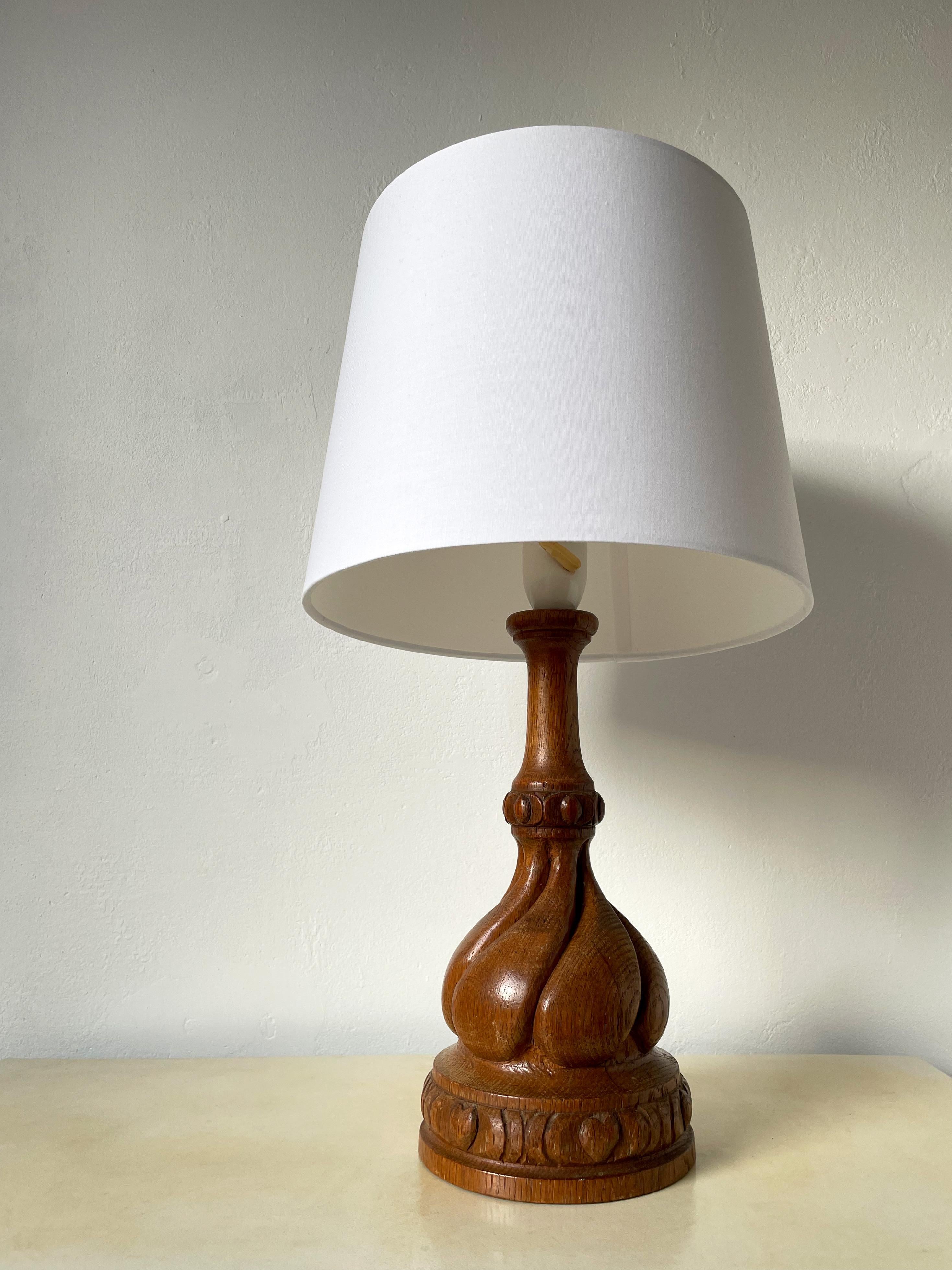 Vintage wooden table lamp with soft, rounded handcarved organic decorations. Clear lacquer. Original fitting with switch. Beautiful vintage condition. 
Scandinavia, 1960s. 
Rewiring upon request - local rewiring recommended.