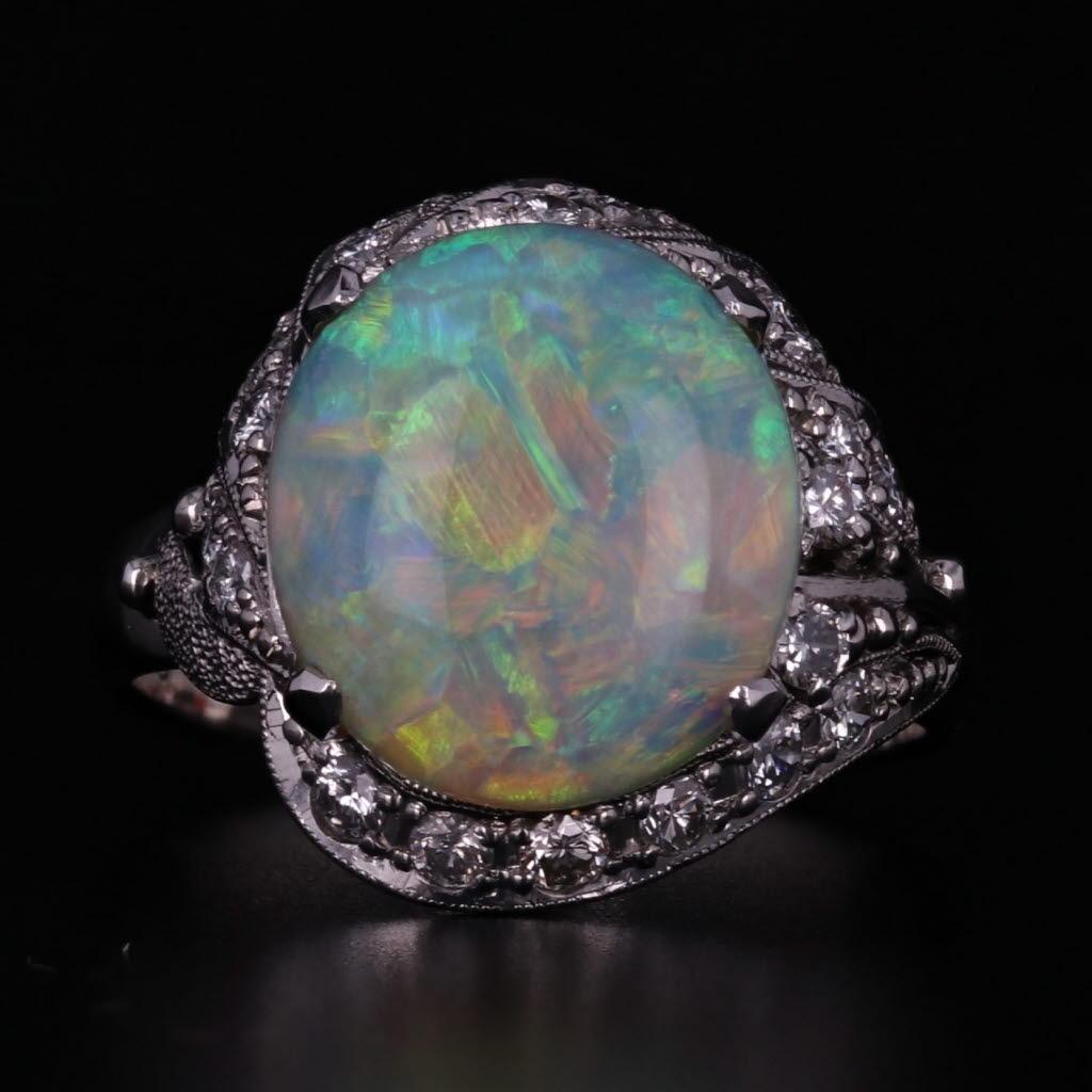 Gemstone Information:
- Natural Opal -
Size - 10.8 x 12 mm 
Cut - Oval Cabochon
Color - Multi-Color

- Natural Diamonds -
Total Carats - 0.43ctw
Cut - Round Brilliant
Color - G - H
Clarity - VS2 - I2

Metal: 900 Platinum
Weight: 6.9 Grams 
Stamps: