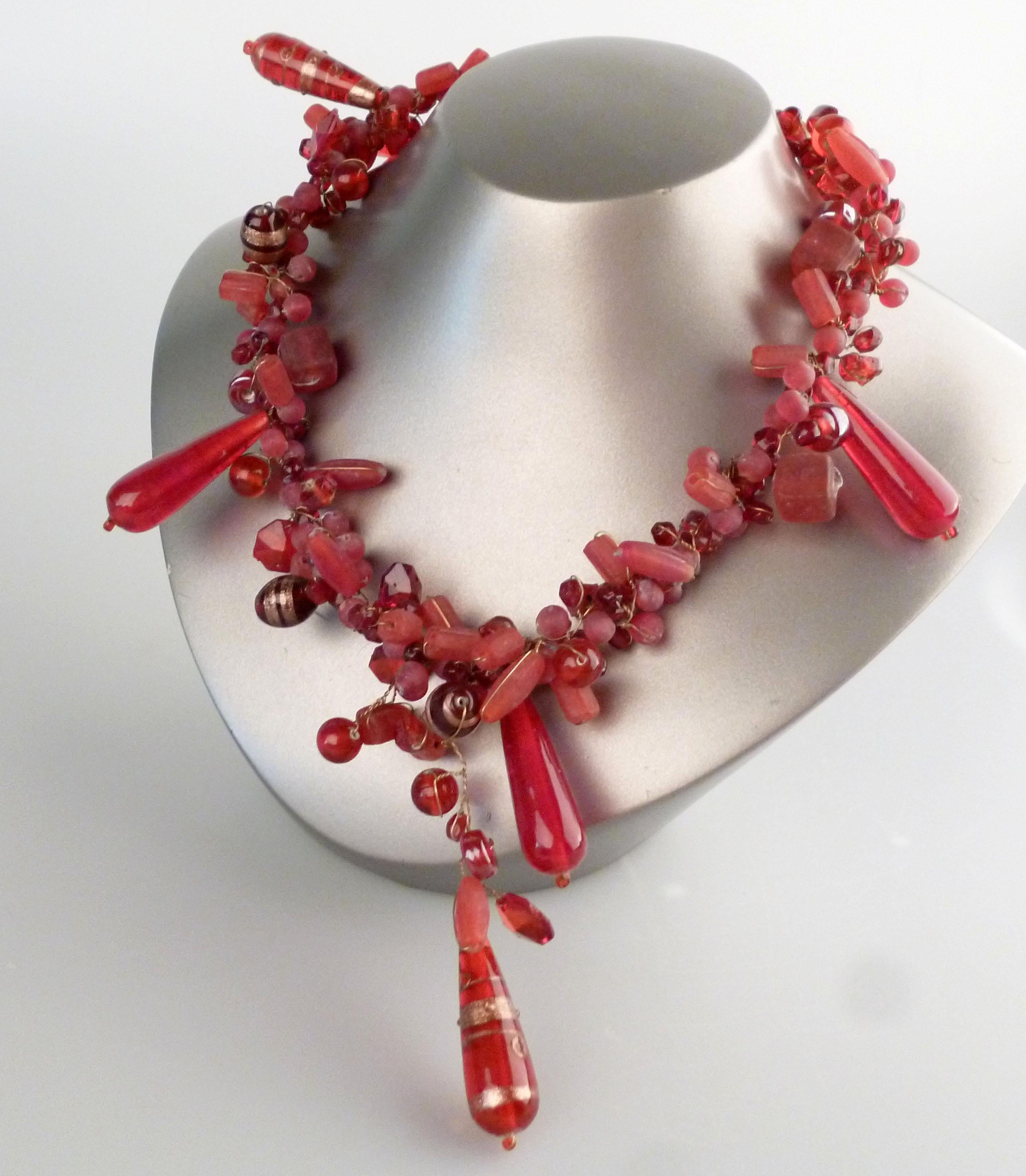 Vintage handcrafted necklace adorned with red Venetian glass beads and ornaments.
