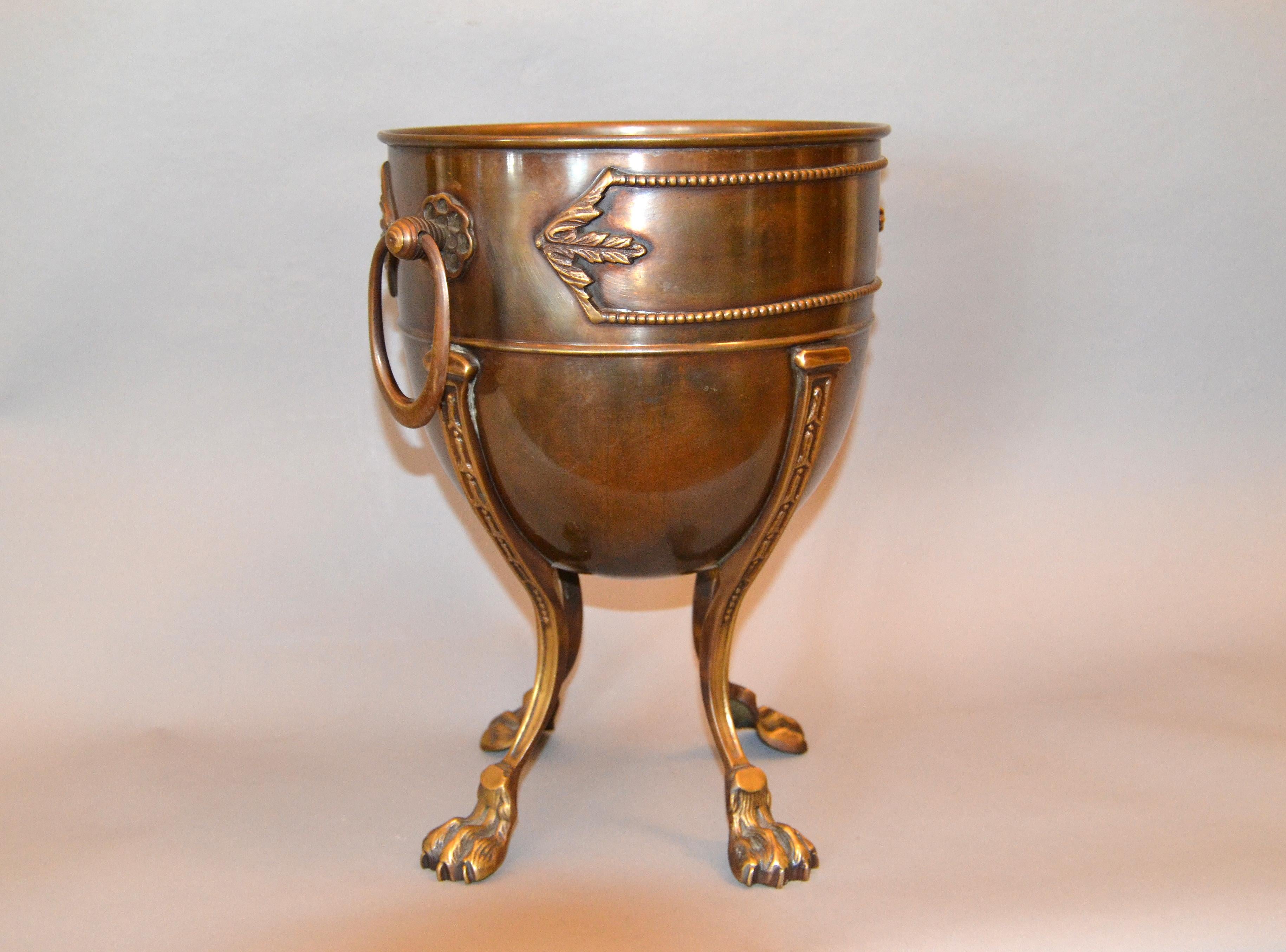 Vintage handcrafted ornate bronze ice bucket or wine bucket with four legs claw feet.
Extraordinary crafted with lots of details.
 