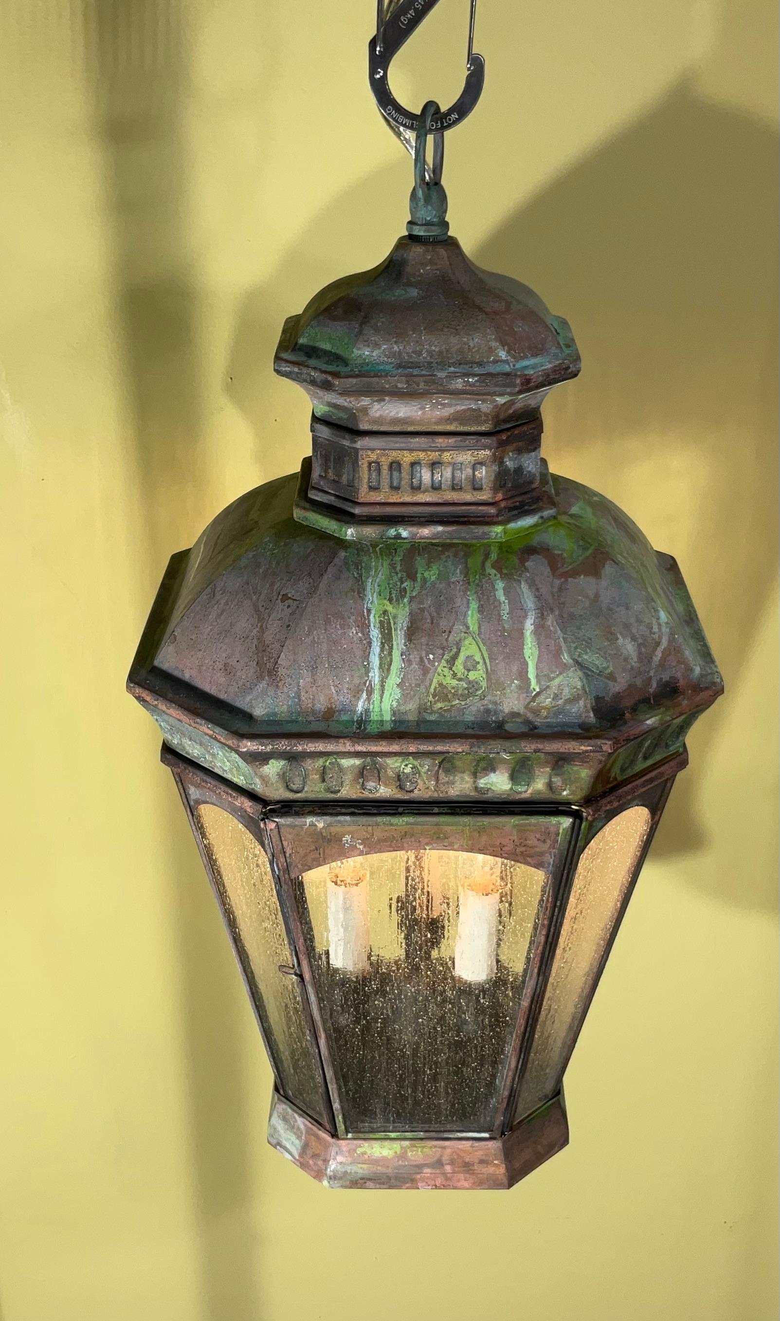 Exceptional s hanging lantern made of handcrafted solid brass ,nice patina ,with three 60/watt lights, textured art glass ,suitable for wet location
great look indoor outdoor. 
canopy and chain included.