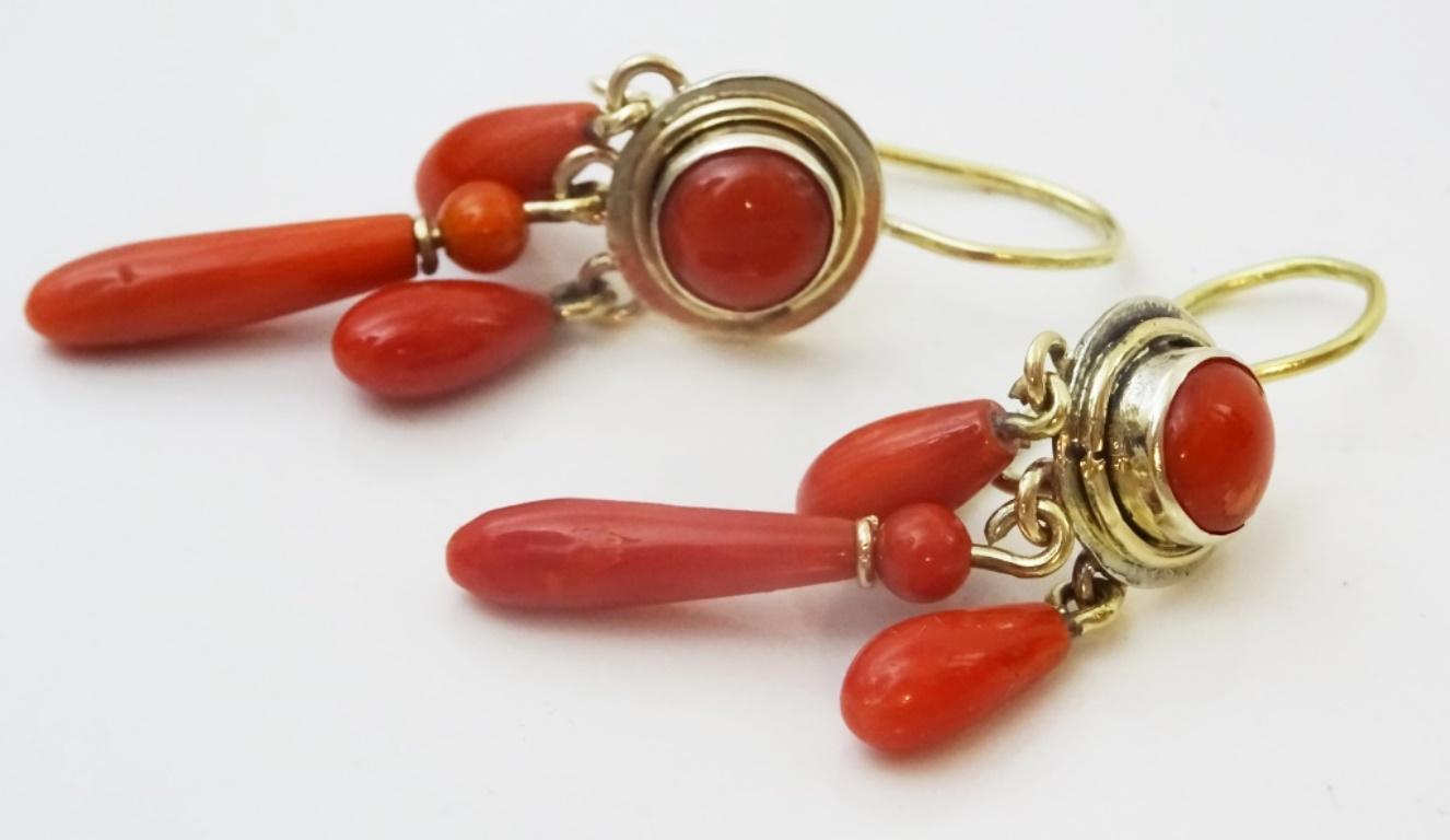 A pair of handmade 14 karat Gold Earrings (marked as well as acid tested ).
They are in the style of Victorian Earrings set with Amazing Red Sardinian corals.
The Beads hanging bellow the set stone are probably original Victorian Pear Shaped