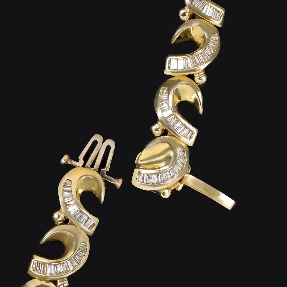 Bold, glamorous, and unmistakably retro — this vintage bracelet is a true statement piece. Meticulously handmade in solid 14k yellow gold, it features an impressive 5.00 carats of natural baguette-cut diamonds that sparkle with crisp