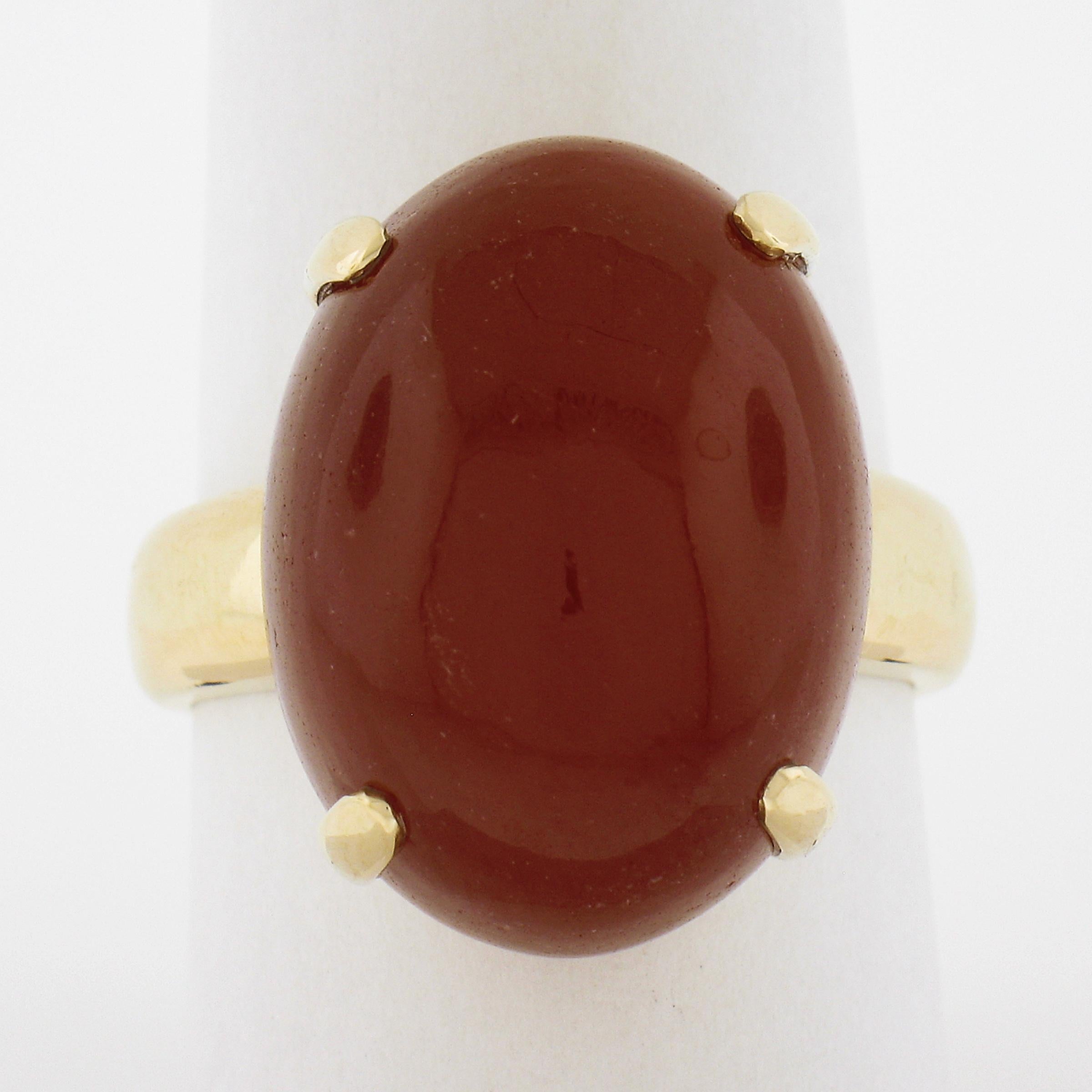 --Stone(s):--
(1) Natural Genuine Carnelian - Oval Cabochon Cut - Prong Set - Rich Reddish Orange Color - 20.5x15.2mm (approx.)

Material: 18K Solid Yellow Gold
Weight: 10.6 Grams
Ring Size: 9.5 (Fitted on a finger. We can custom size this ring -