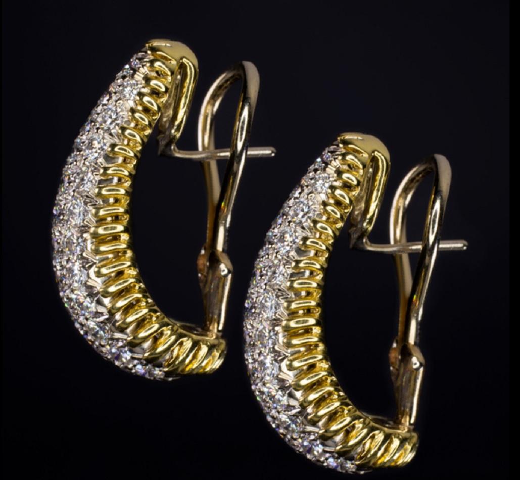 This stunning pair of original vintage diamond earrings are handmade with exceptional care and very high quality diamonds. The earrings are gracefully domed and elegantly constructed with borders of twisting 18k yellow gold. The high quality F-G VS