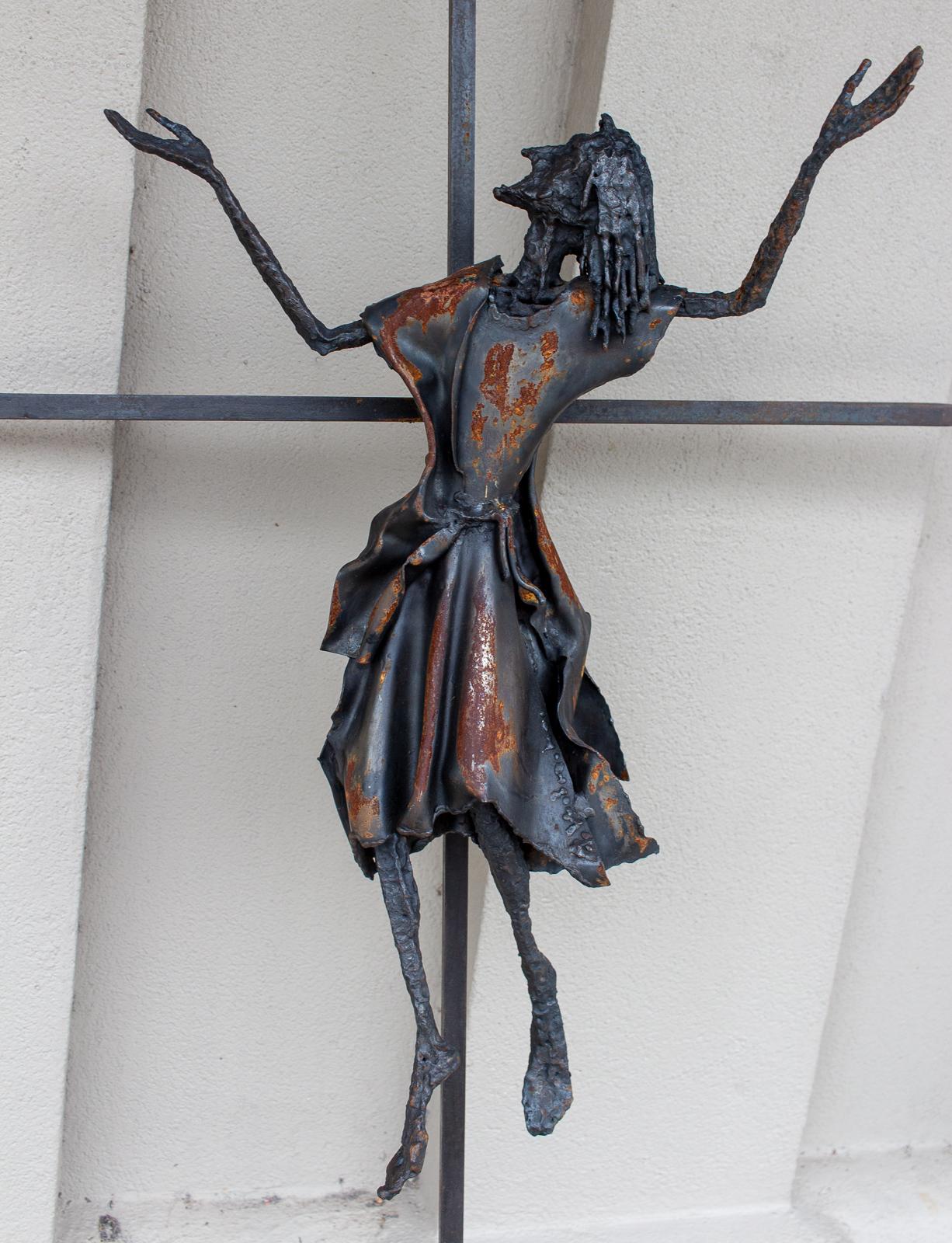 This hand forged iron crucifix features an image of Christ that leaves the viewer with a feeling of hopefulness. Eyes to the heavens, and arms raised, this iron sculpture seems to almost float. The artist is unknown, but this piece was sourced in
