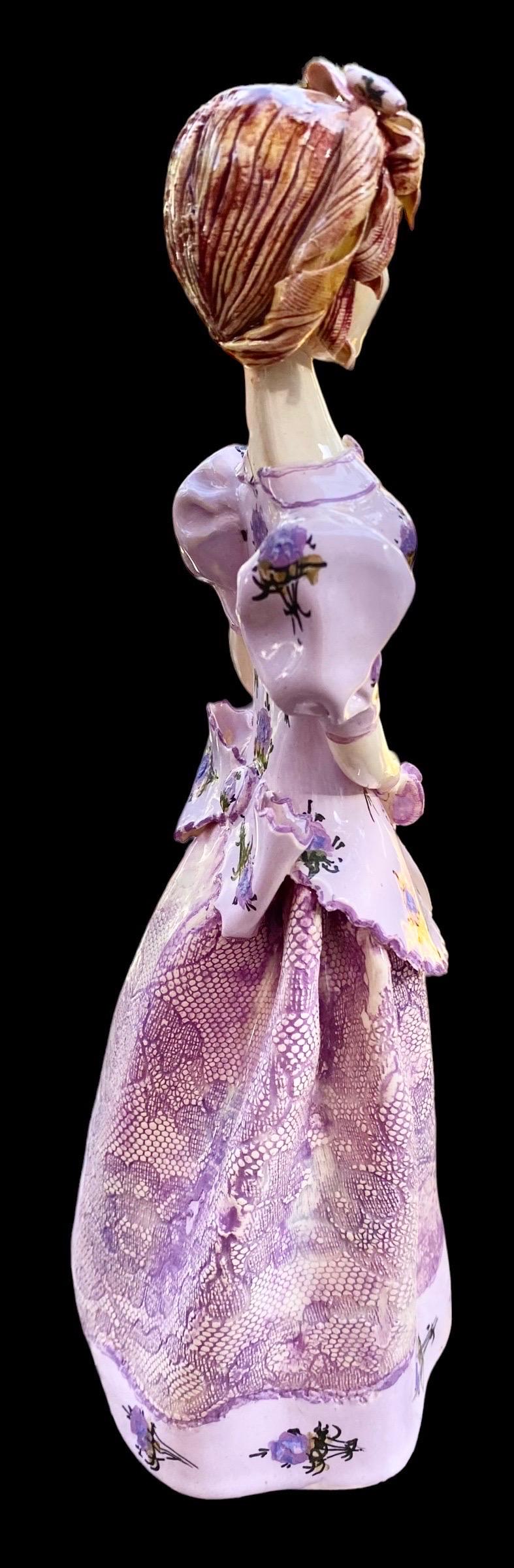 This is a lovely and delicate hand made clay art girl figurine in a lavender print dress with a lace overlay that stands 7