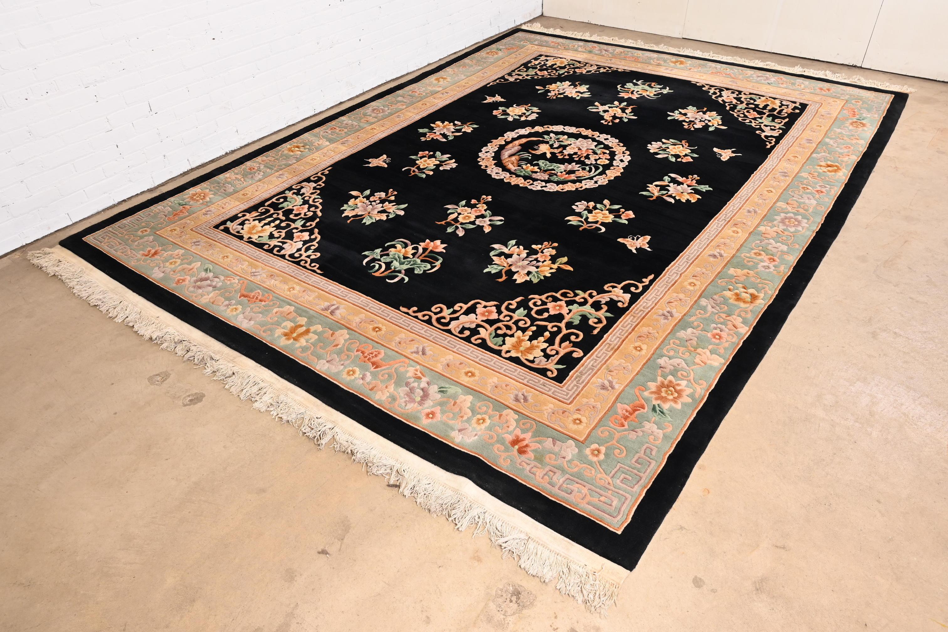 A beautiful handmade vintage Chinese sculpted wool area rug.

Mid-20th century

Nice floral design with bird and butterflies, with predominant colors in light green, peach, and black.

Measures: 9' x 13'

Good original vintage condition. Rug