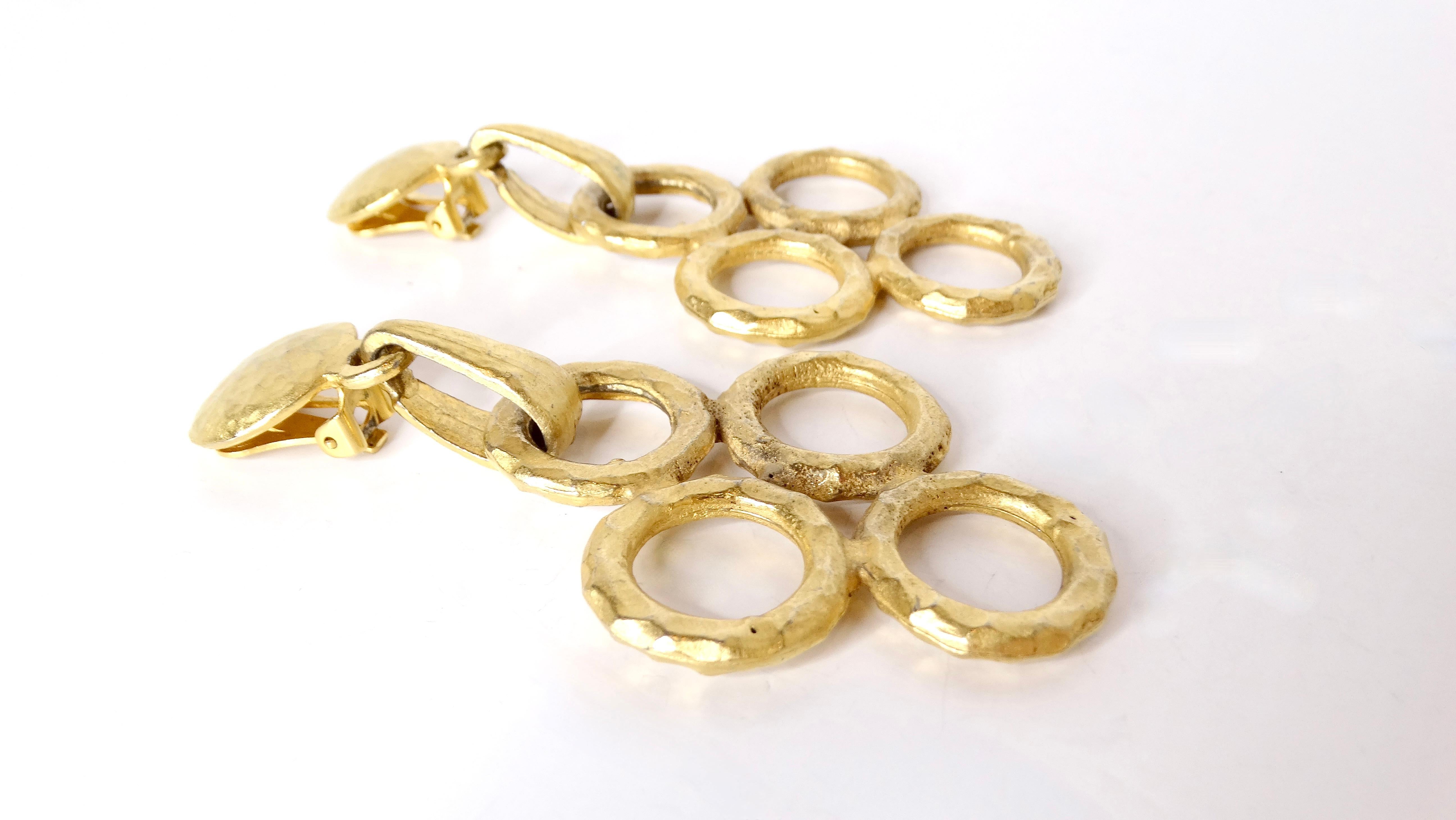 Elevate your accessory game with these stunning Vintage Handmade Hammered 18k Gold Plated Round Link Dangle Earrings. Featuring four intricately crafted gold-plated circles arranged in a stylish north-south-east-west configuration, these earrings