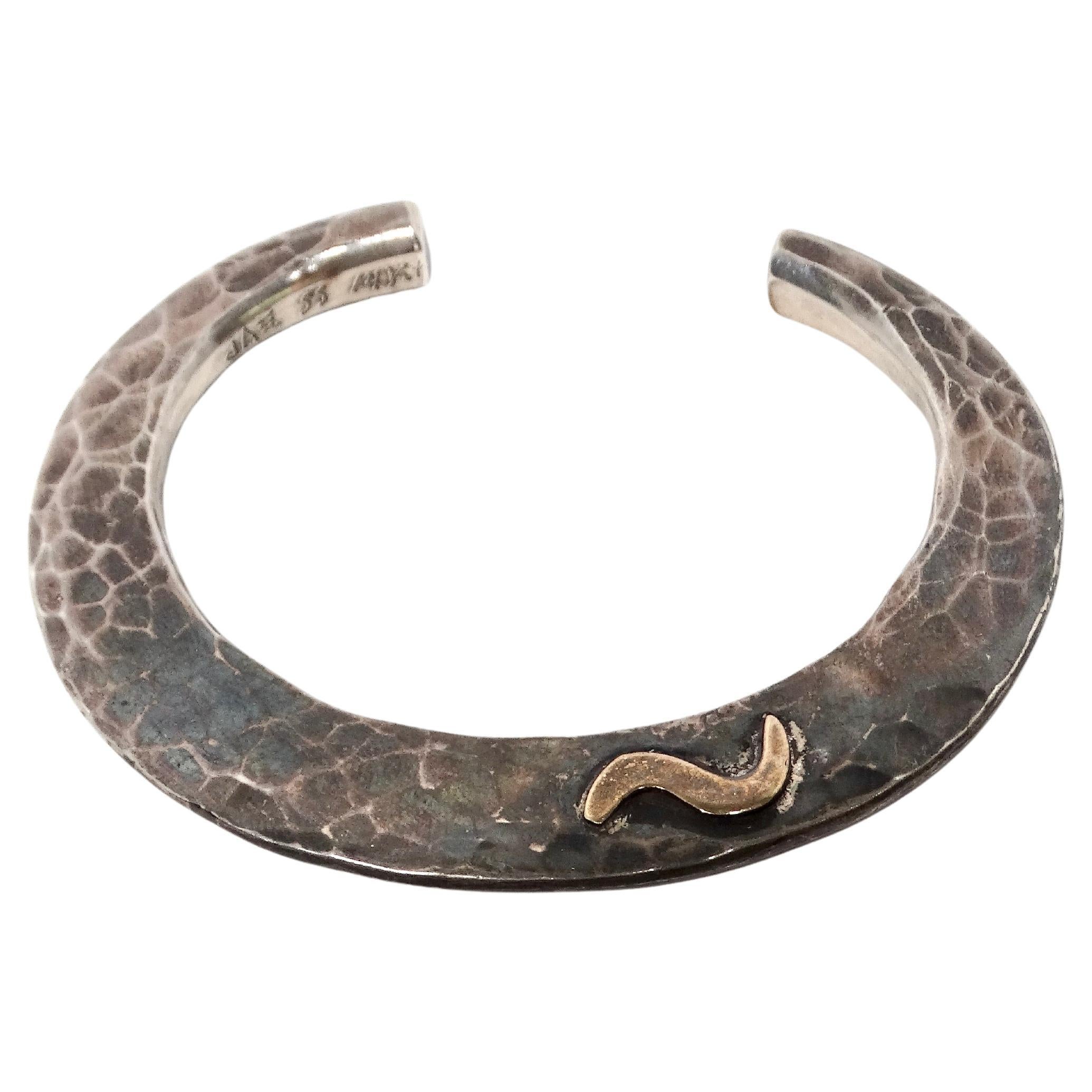 Elevate your accessory game with this exquisite Vintage Handmade Hammered Sterling Silver & 14k Gold Cuff, an exceptional piece that seamlessly blends timeless craftsmanship with modern elegance. The unique hammered texture adds a distinct