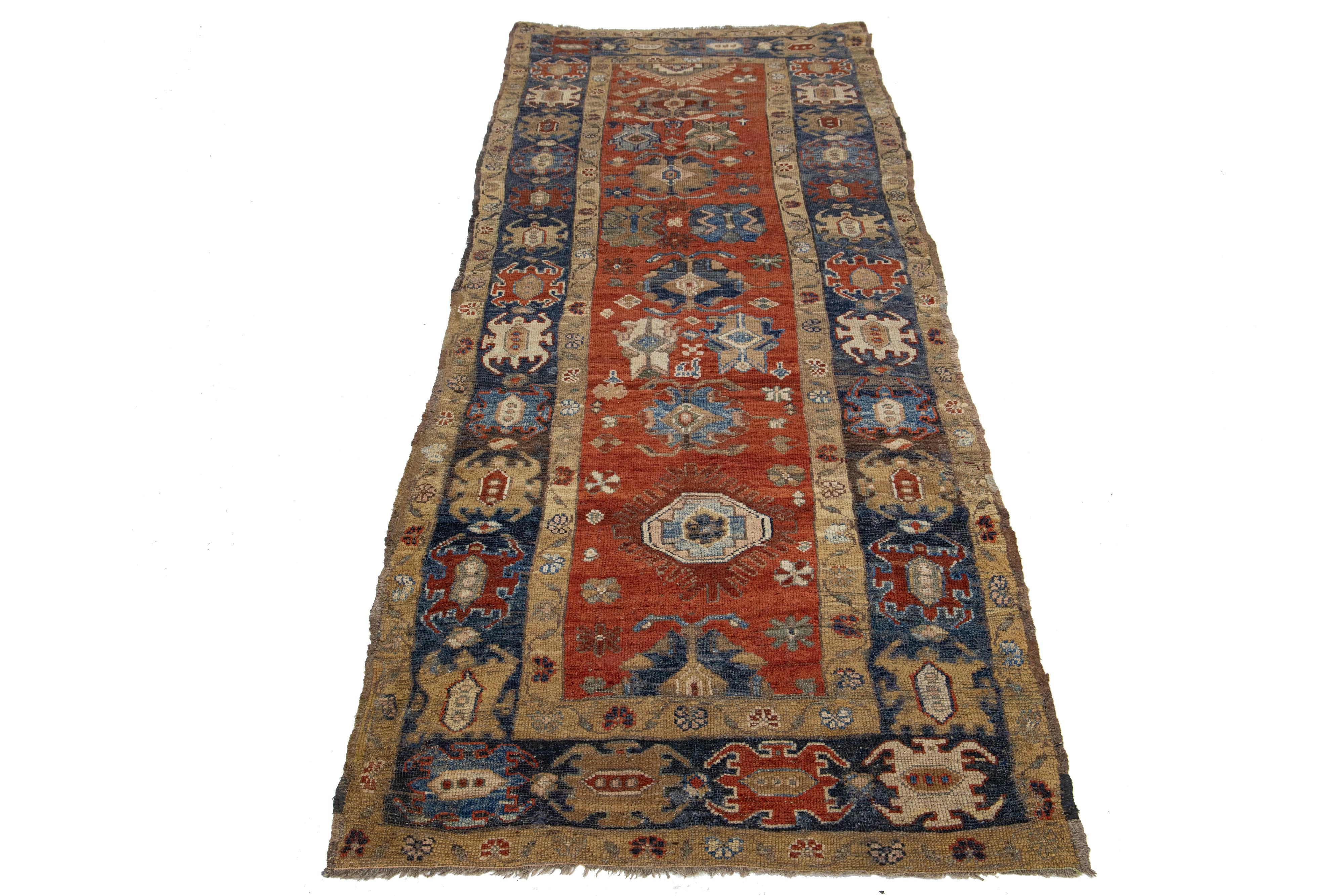 Beautiful vintage Heriz wool runner with a red field, the fame of navy-blue. This rug has multi-color accents in an all-over geometric design.

This rug measures 3'7