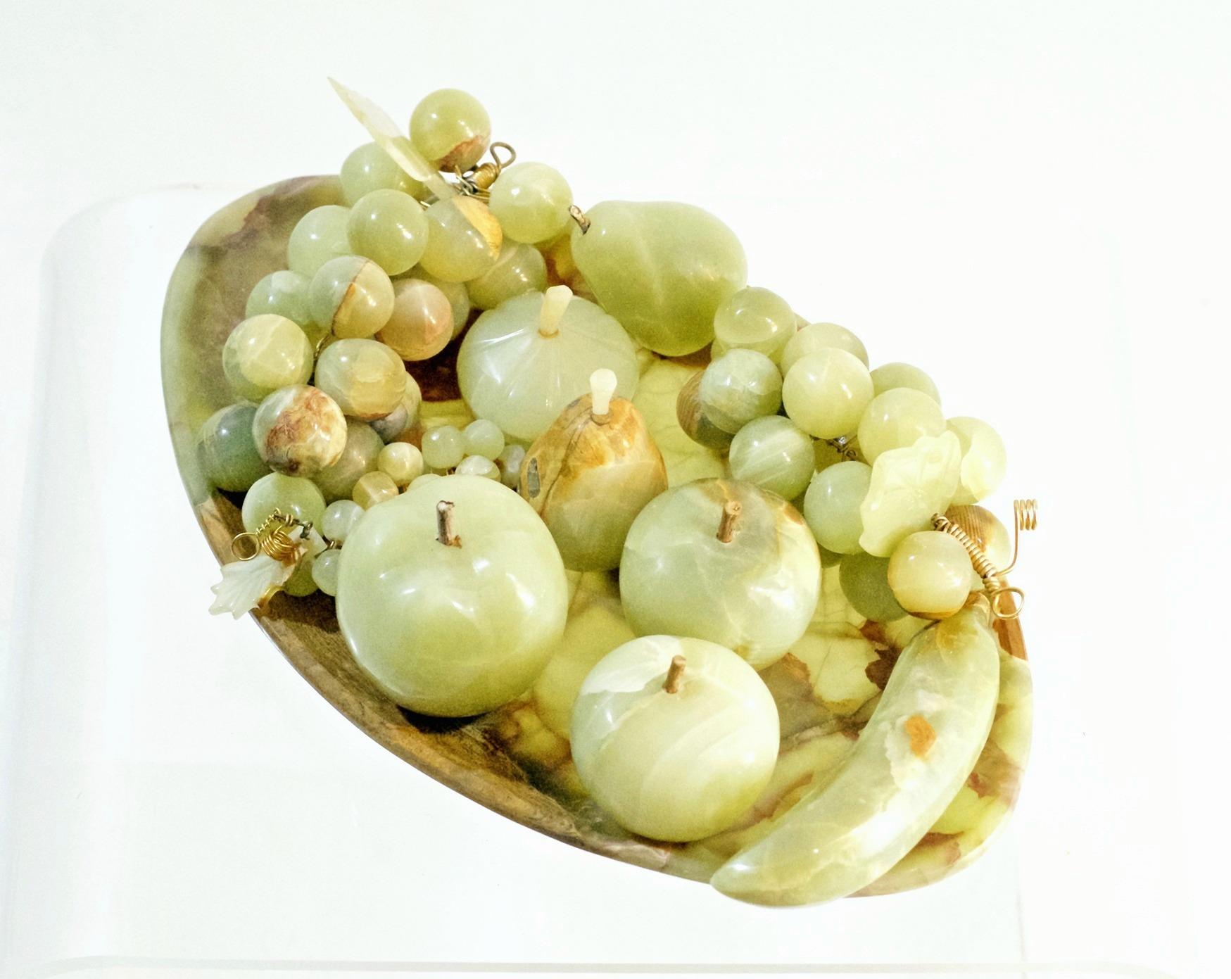 A decorative oval handcrafted tray filled with different fruits such as grapes, fig, apples and pear in the same stone. In excellent condition.