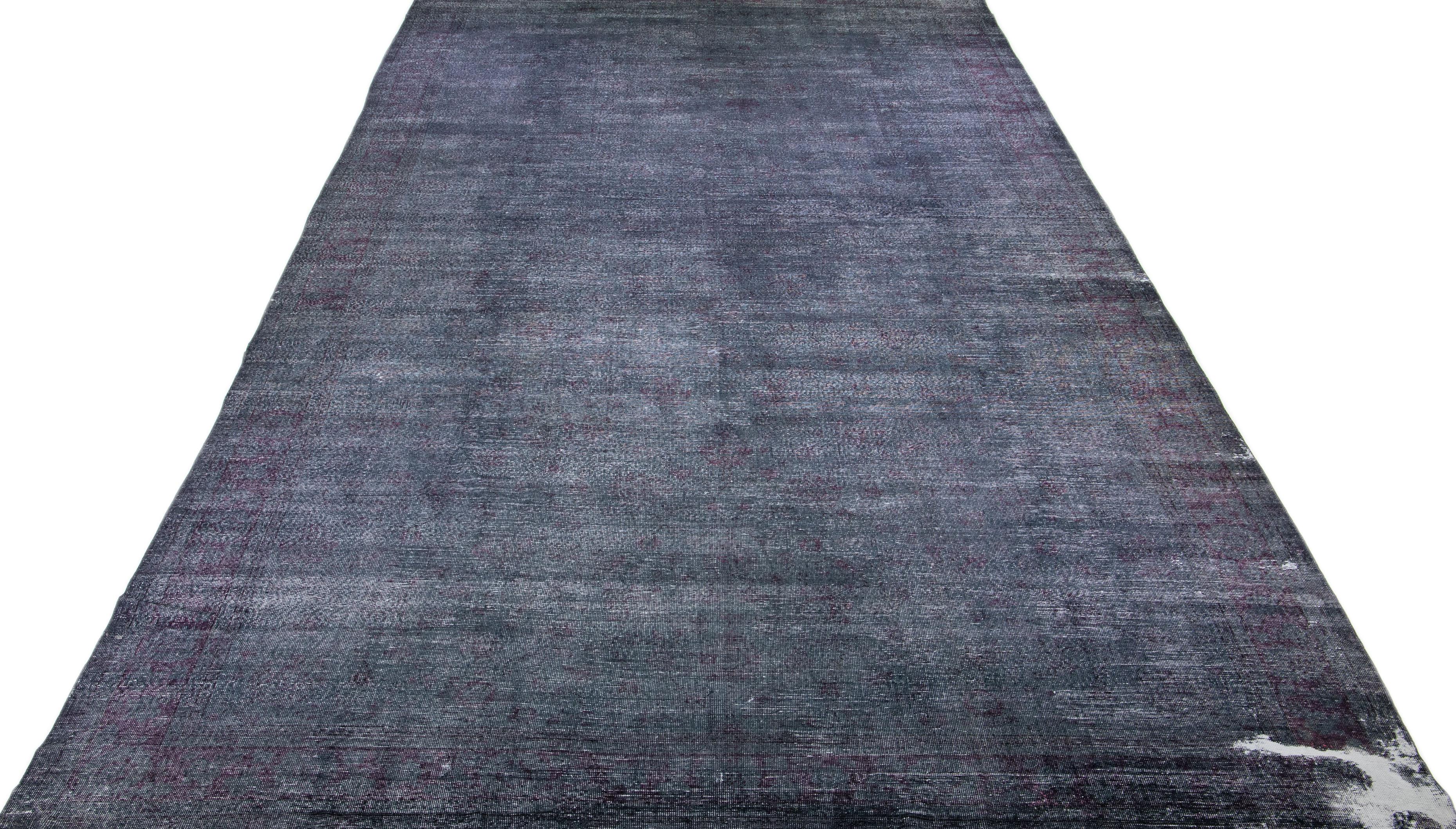 Beautiful Vintage Overdyed hand-knotted wool rug with a gray field. This Turkish rug has pink accents in an all-over floral design.

This rug measures: 12' x 25'11