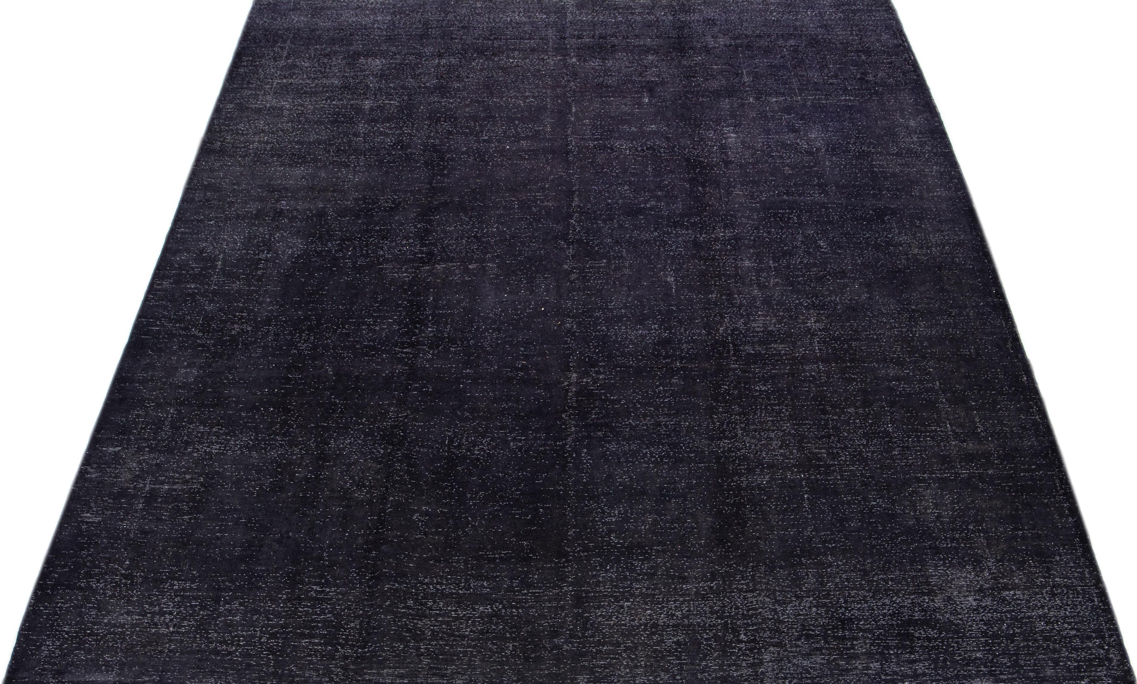 Beautiful Vintage Overdyed hand-knotted wool rug with a gray-charcoal color field with an allover motif. This carefully crafted rug provides long-lasting durability and a stylish look that can elevate any room.

This rug measures: 9'7