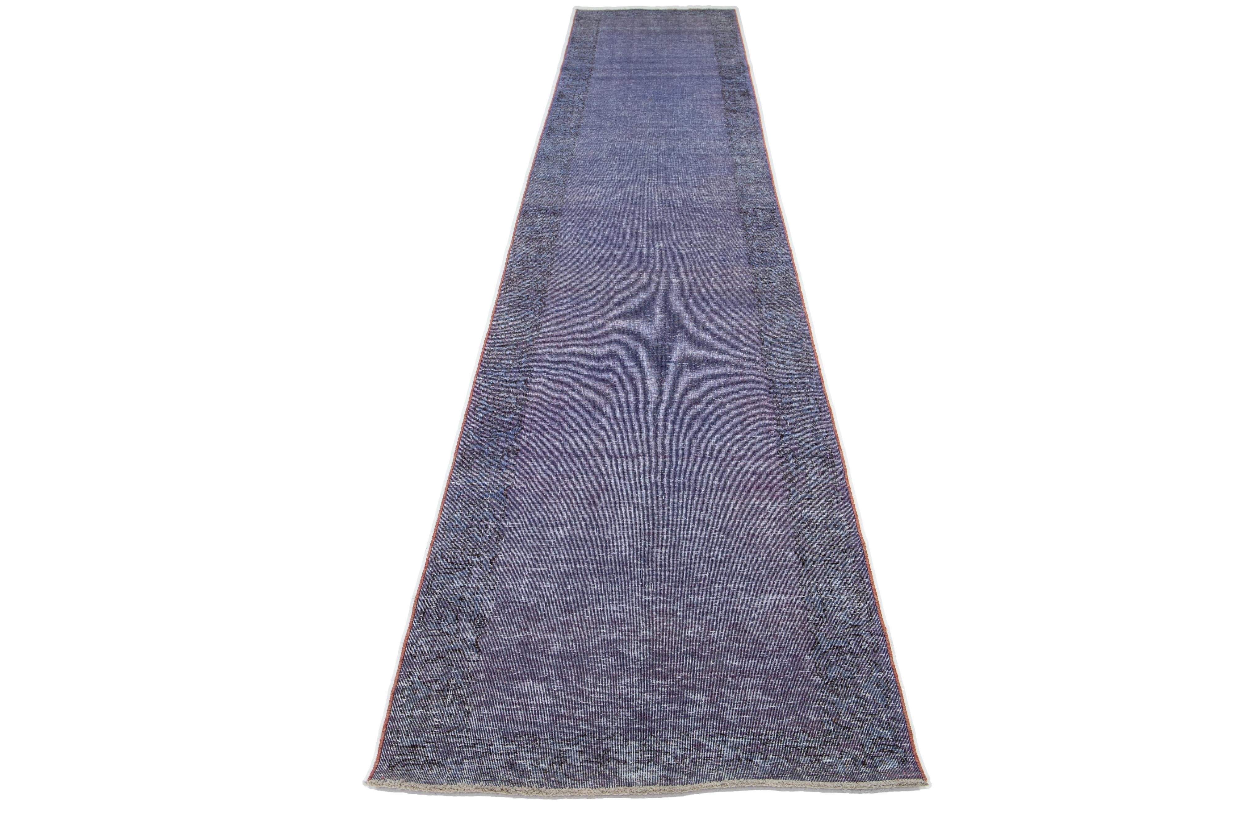 This vintage Overdyed Persian wool rug boasts a captivating Periwinkle color field with charming brown floral accents.

This rug measures 2'8