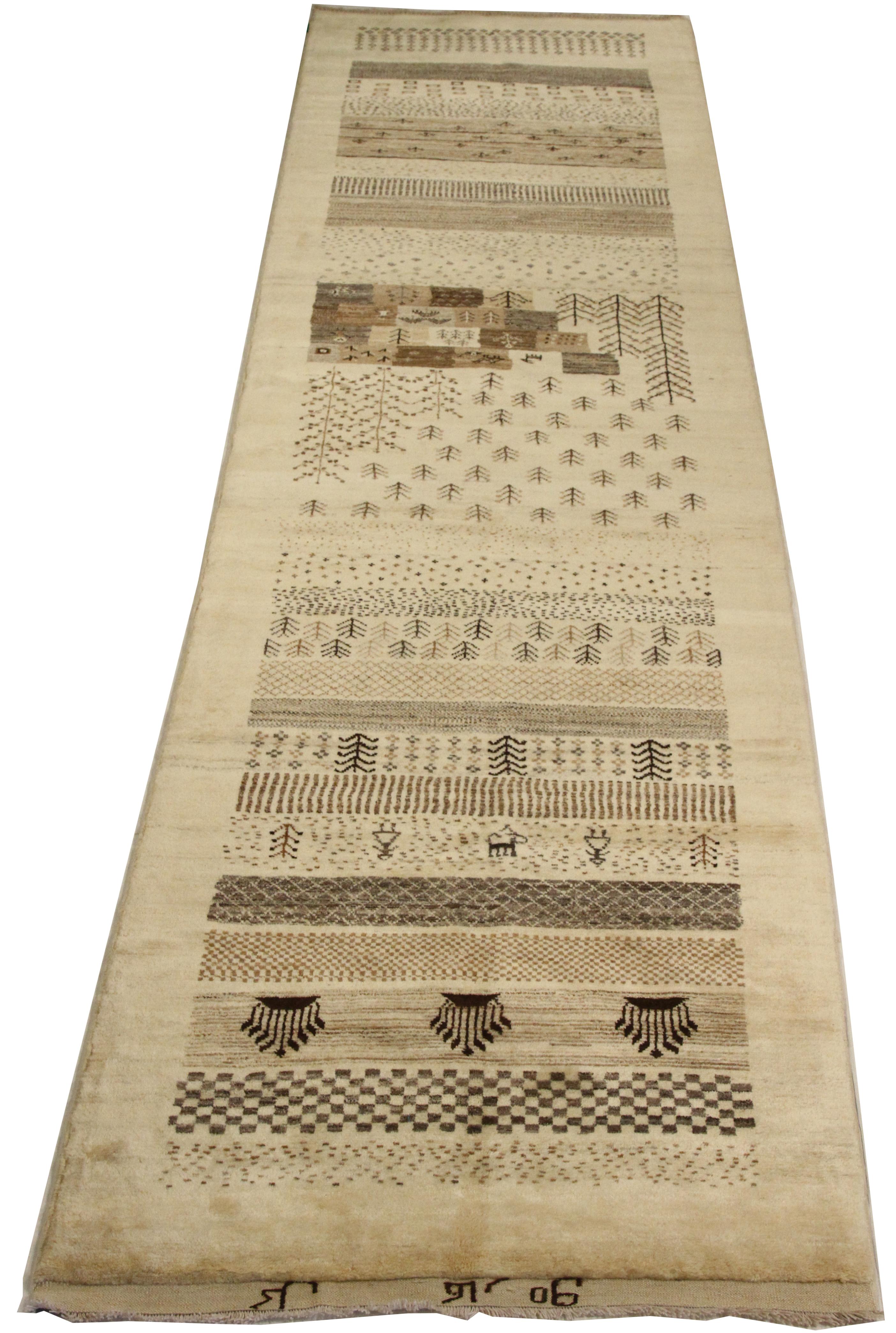 Vintage handwoven Persian runner rug made from fine wool and all-natural vegetable dyes that are safe for people and pets. This beautiful piece features simple geometric patterns which Gabbeh rugs are known for. Persian tribal rugs like Gabbeh are