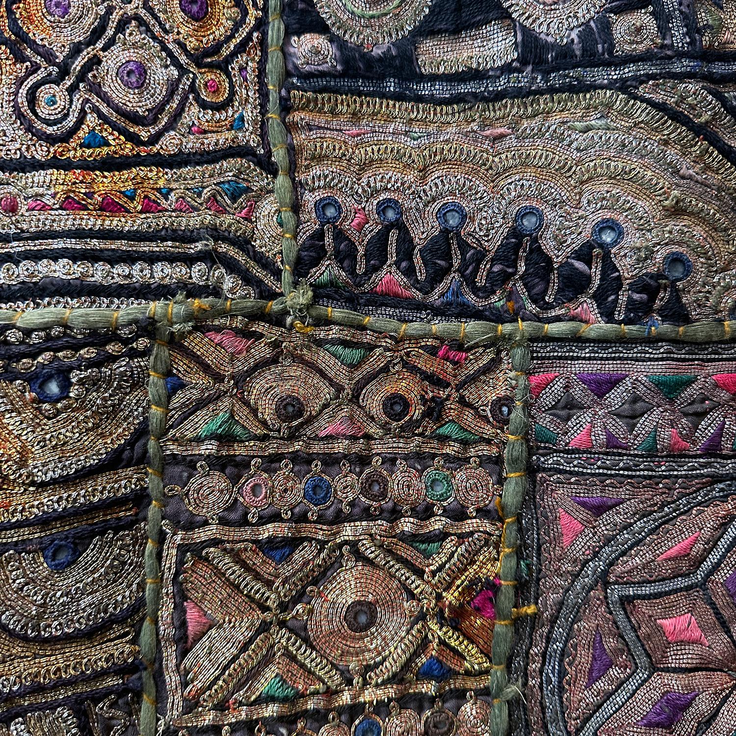 Vintage Rajasthani Patchwork Tapestry, handcrafted, of several small irregular embroidered “patches” heavily embroidered with gold and silver paper-wrapped threads  couched down in a multitude of colors, some with reflective mirror backed portions,