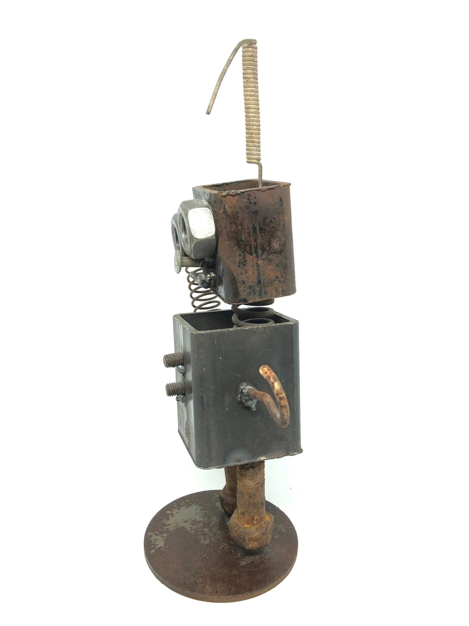 A handmade scrap metal robot statue. Some parts are rusty some with patina. A nice architectural sculpture for every living room or men’s cave. Some scratches and a nice patina due to the age.