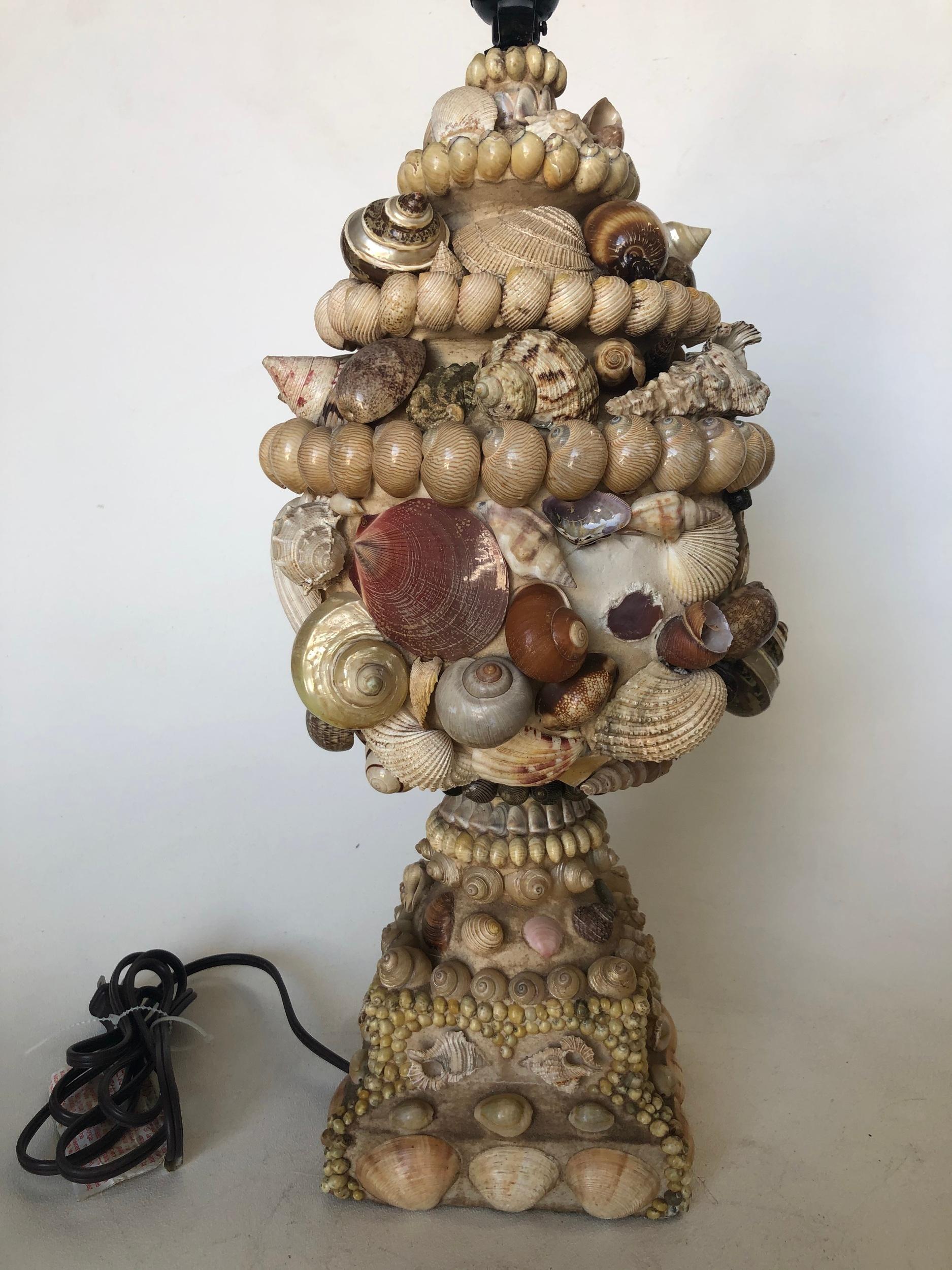 Large scale handmade sea shell mosaic folk art lamp signed Nate Rickett.

Measures: 26