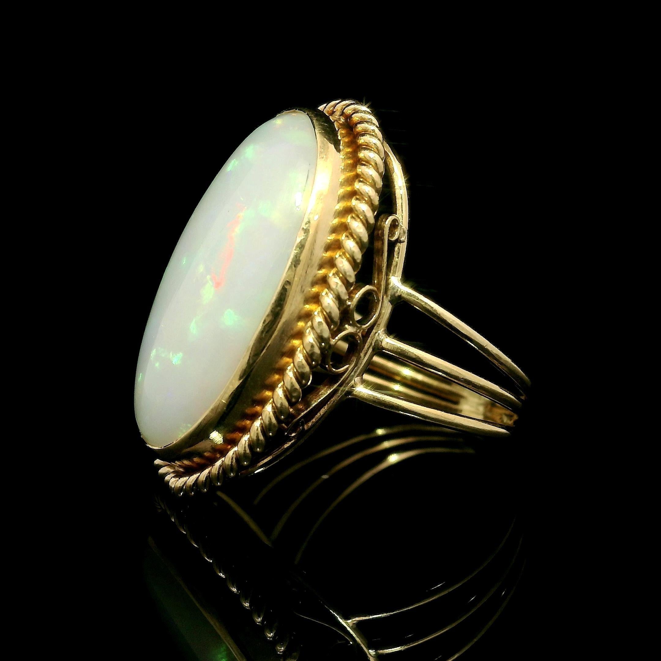--Stone(s):--
(1) Natural Genuine Opal - Oval Cabochon Cut - Bezel Set - White Base Color w/ Nice Play of Color- 20.54x12.08mm (approx.)

Material: Solid  18k Yellow Gold
Weight: 7.44 Grams
Ring Size: 6 (Fitted on a finger, item can not be