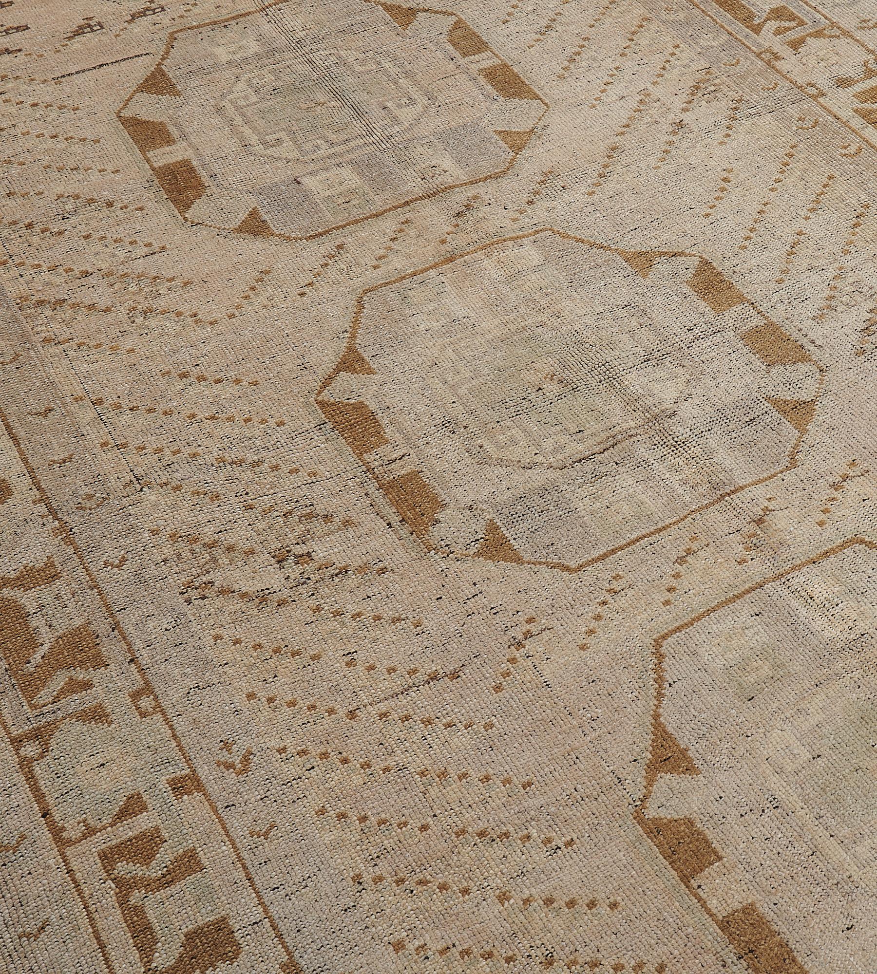 This vintage hand-woven Turkish Anatolian rug has a beige field of diagonal rows of geometric motif with central column of octagonal lozenge medallions, in a golden brown geometric rosette vine border.