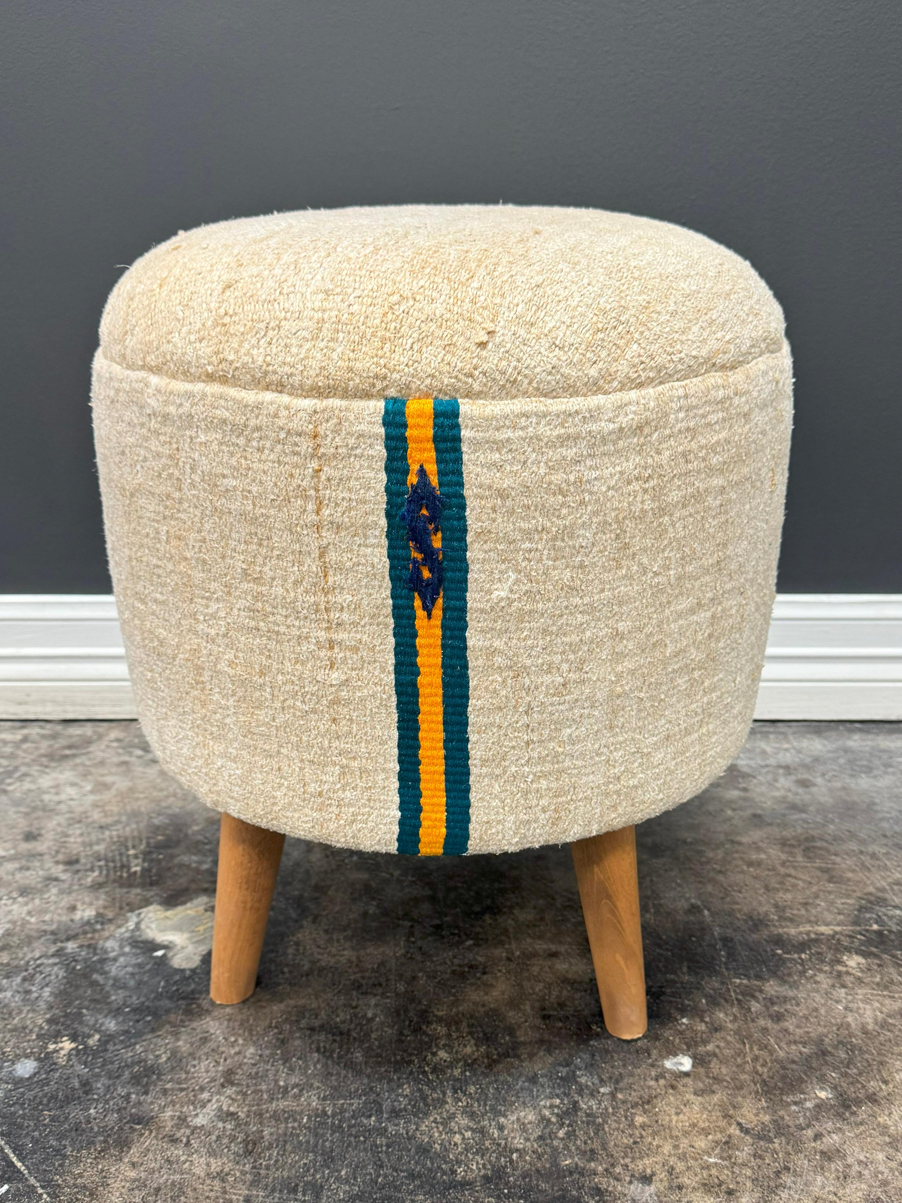 Introduce timeless charm and eco-conscious living into your space with this 1960s Beige & Teal Vintage Handwoven Hemp Pouf. This versatile piece doubles as a comfortable footstool and extra seating, making it a functional and stylish addition to