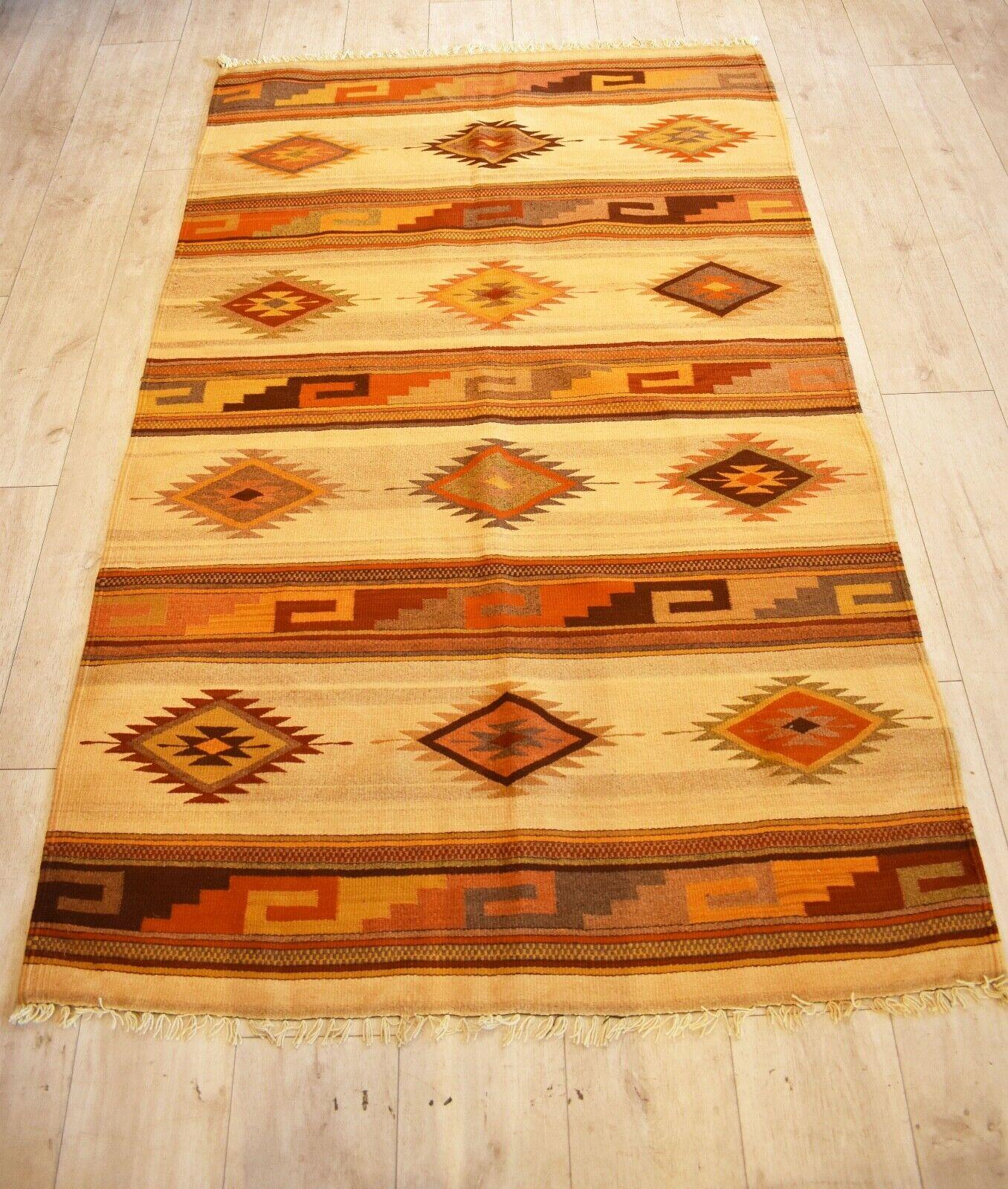 Very rare and unusual beautiful handwoven vintage Kilim runner
with Classic Indian Tribal patterns in shades of
Earthy brown, orange, green, orange & black on a straw coloured background
with a beautiful tasseled edges.
Handwoven with natural