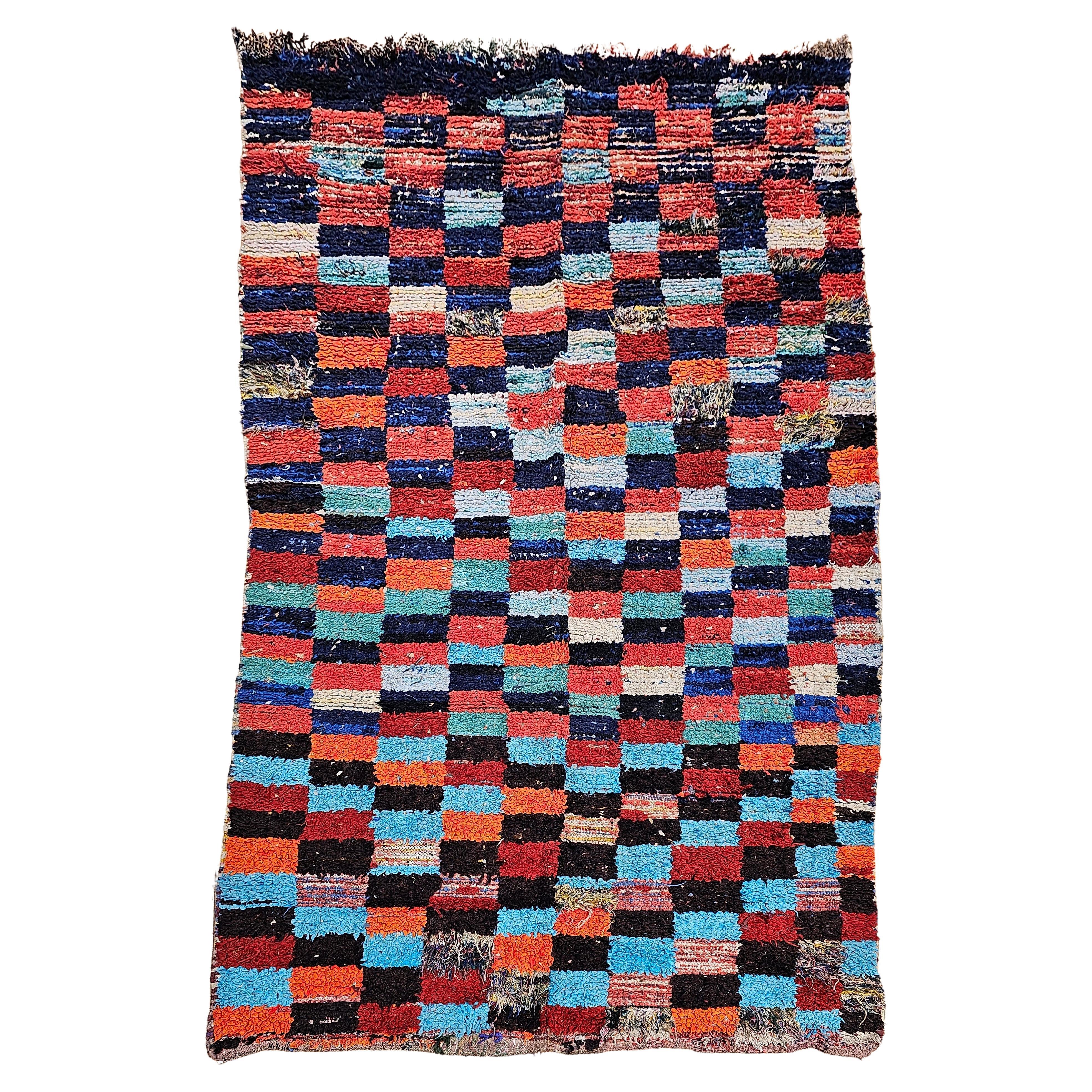 Vintage Moroccan Boucherouite shag area rug is in a colorful checkered pattern. The many colors include green,  blue, red, orange and many more. The word 