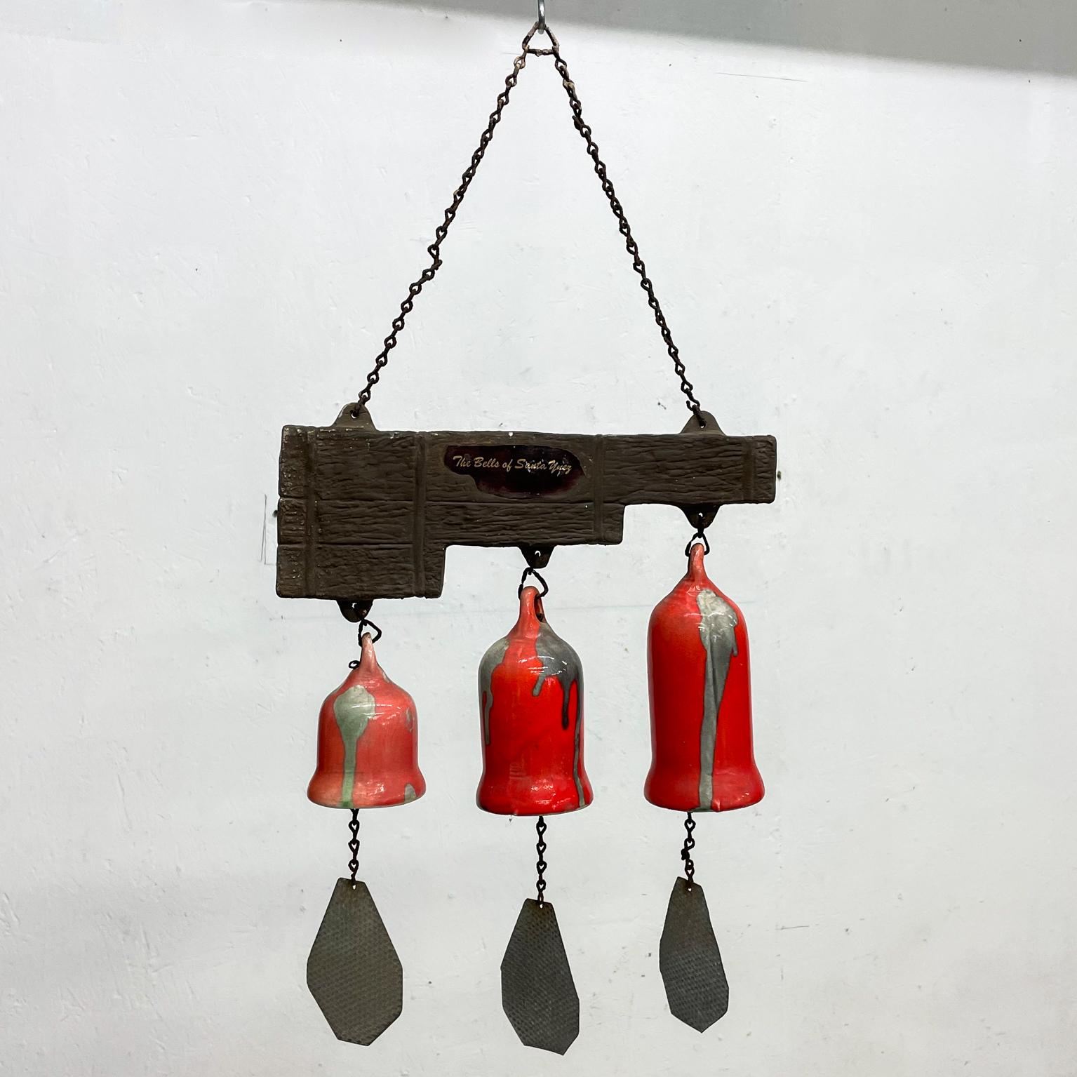 Three Bell Chime
Vintage hanging pottery wind chime bells of Santa Ynez California
Measures: 12.5 width x 26.25 tall x 3.25 diameter
Stamped Windchime, the Bells of Santa Ynez, Santa Barbara Ca
Three bells made in pottery, orange & brown
