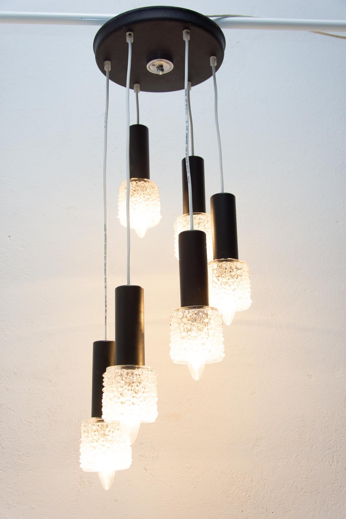 Vintage hanging chandelier from Instala Decín company, hanging six cut glass lamshades at 6 insulated electrical cables. In the style of Italian chandeliers. New wiring. Material: metal, cut glass.

This is a fixture of the 60/70´s made in