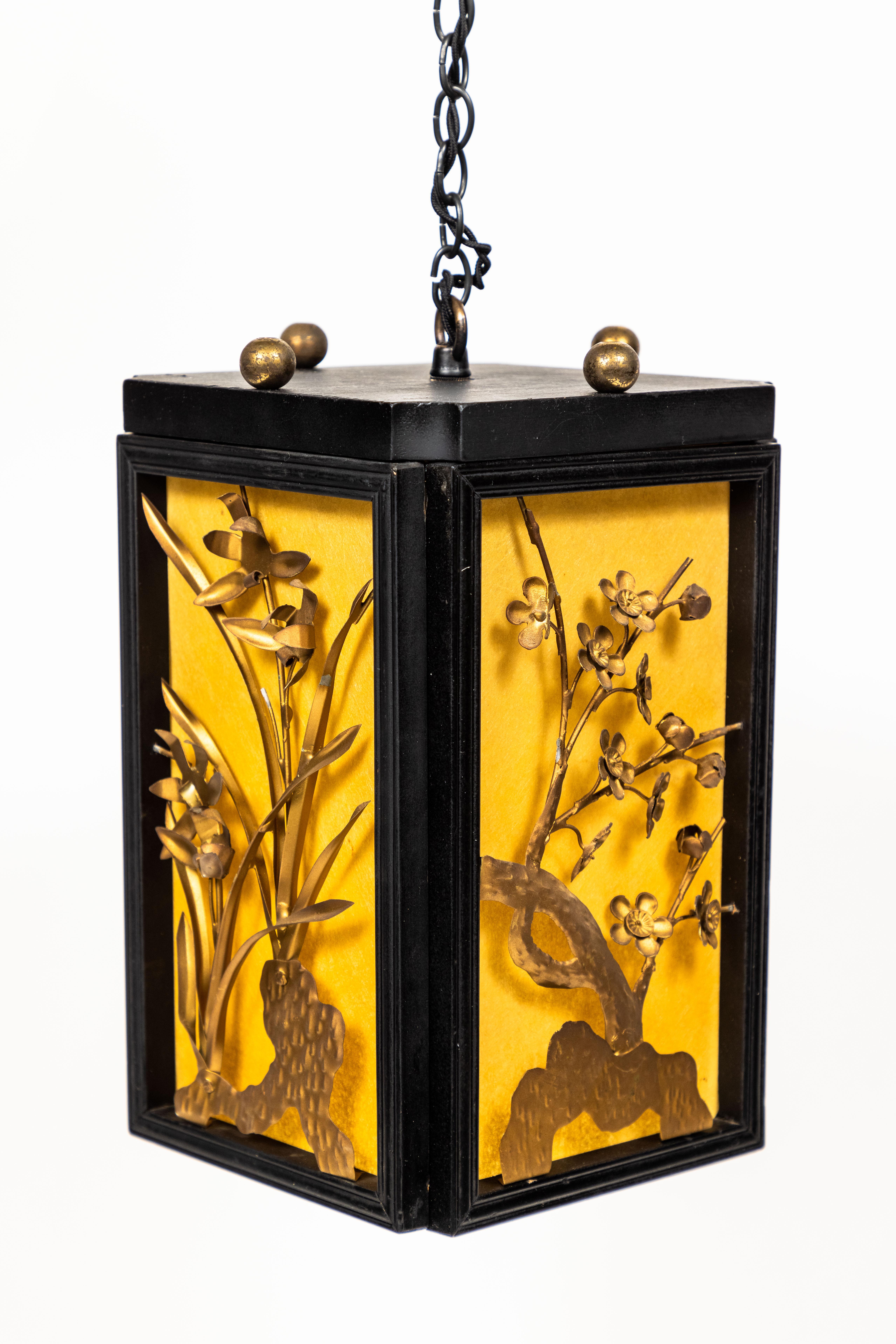 Vintage hanging chinoiserie lantern with black wood frame, natural parchment side panels and gold metal floral motif.

Newly rewired.

Measures: 7