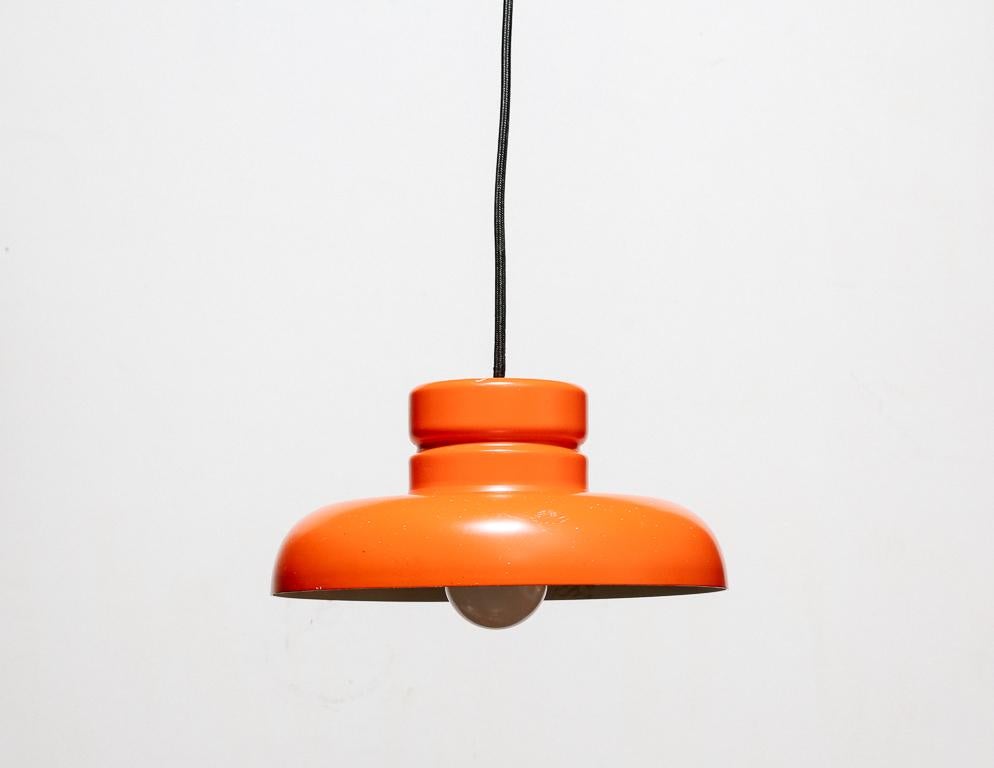 Vintage hanging lamp by RAAK, Holland. Red-orange finish.