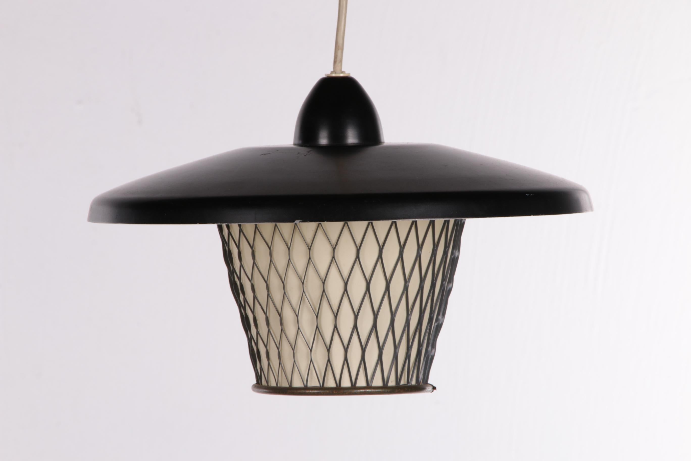 Vintage hanging lamp comes from Scandinavia, made in the 1960s.


This is a beautiful black metal hanging lamp made of metal net and smooth metal.

The inner lining of the lamp is made of a kind of plastic.

The hood is made of smooth metal