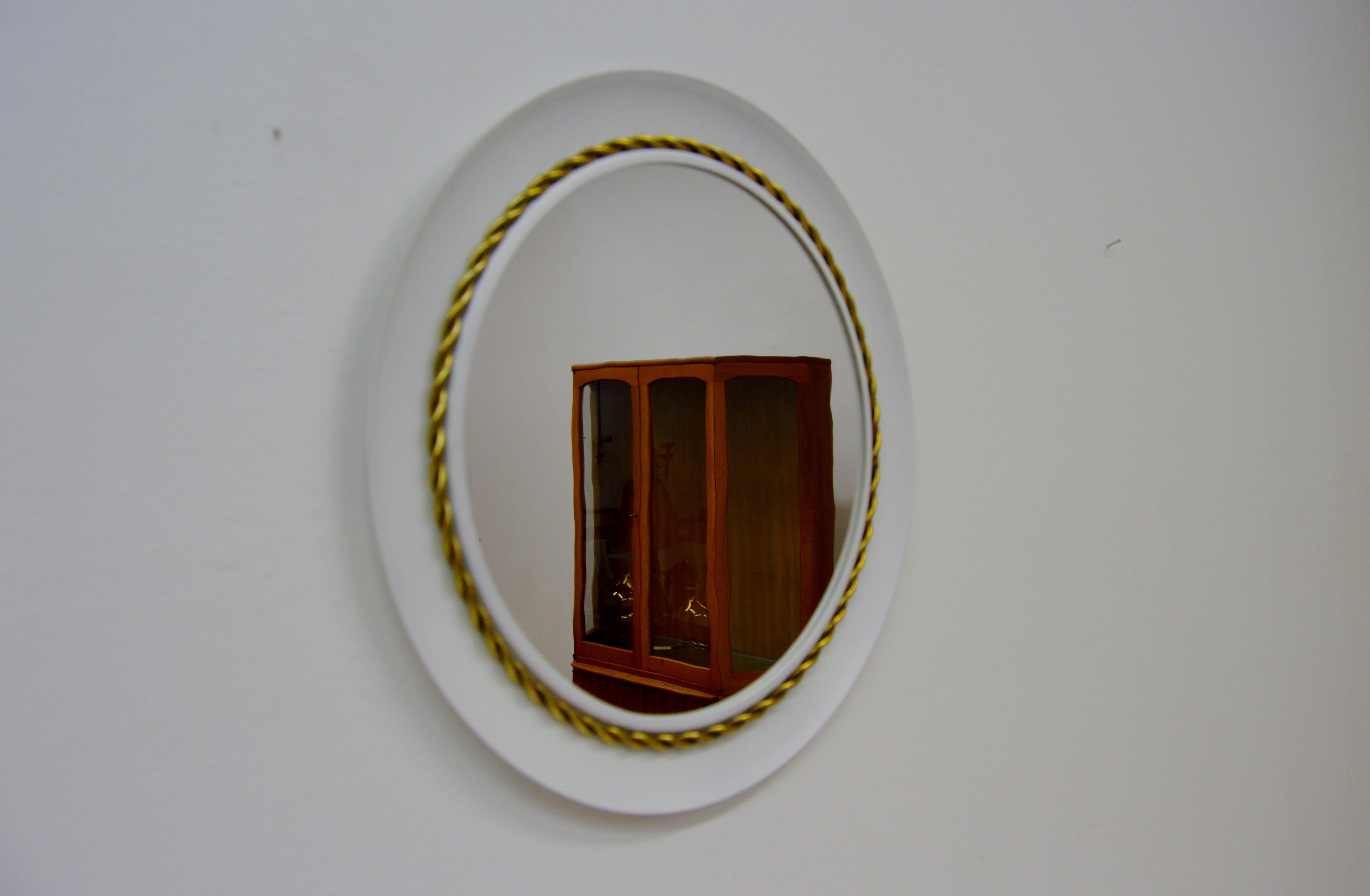 Circular white metal mirror with brass decor.
Designed by Hans-Agne Jakobsson, Markaryd Sweden.