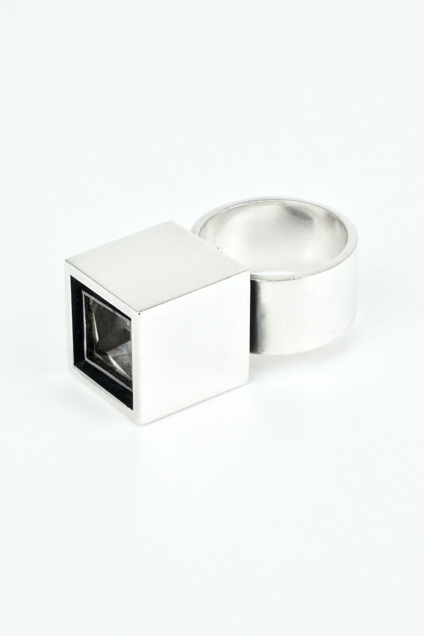 A solid silver and rock crystal box ring - Hans Hansen - a rare modernist ring with a central custom square cut clear rock crystal stone bezel set in a heavy gauge shadow box frame above a wide flat shank - this bold design from this well recognised