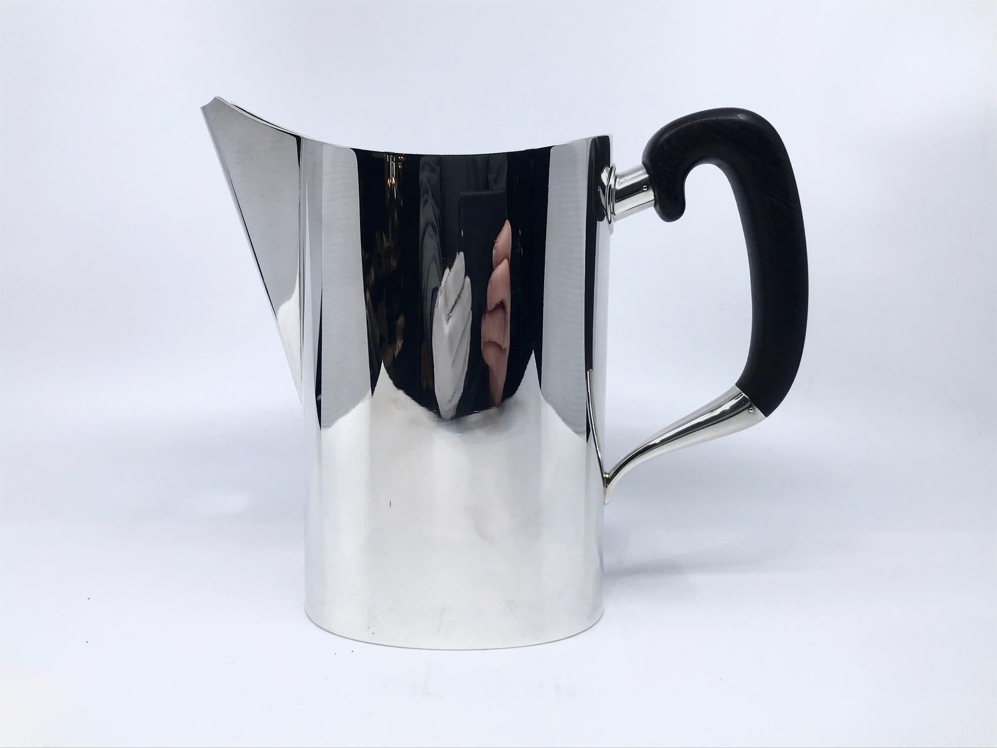 This is a Mid-Century Hans Hansen sterling silver water pitcher with walnut handle, design #392 from 1948. Hans Hansen is one of the premier Danish silver makers, Karl Gustav Hansen is the son of founder Hans, it was Karl Gustav’s designs that
