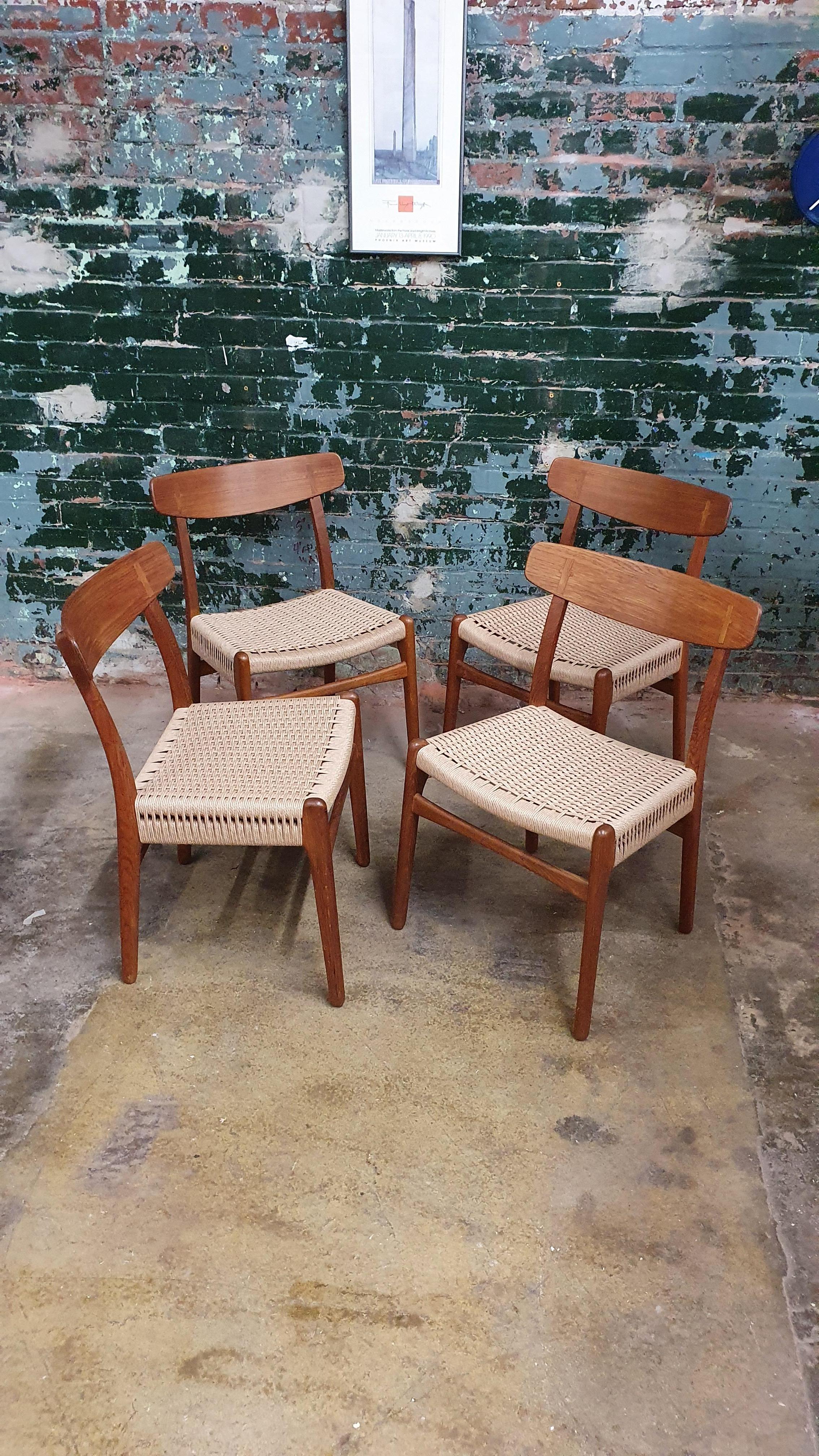 Beautiful oak and teak side chairs model CH23 for Carl Hansen & son by Hans Wegner. this timeless design one of the well known designs of dining chairs. they feature oak frames with bent wood back rests with the classic inlayed teak on the back